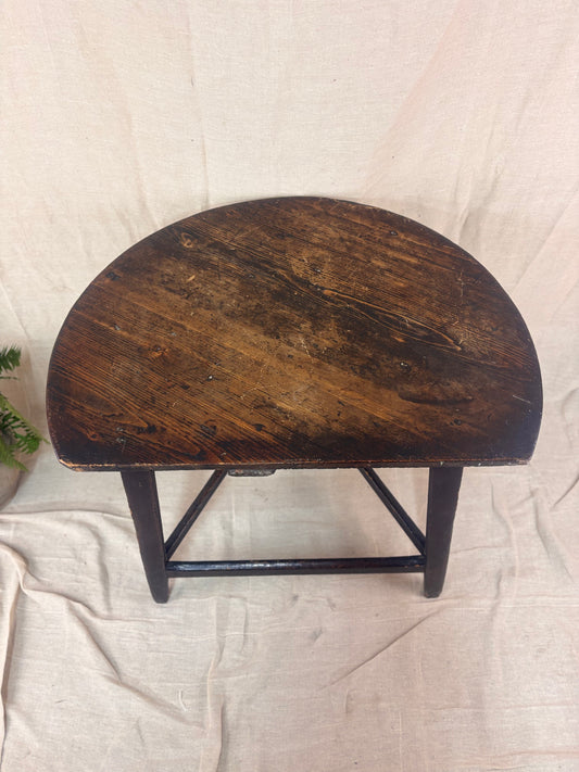 Wooden table with a dark finish on a light fabric background