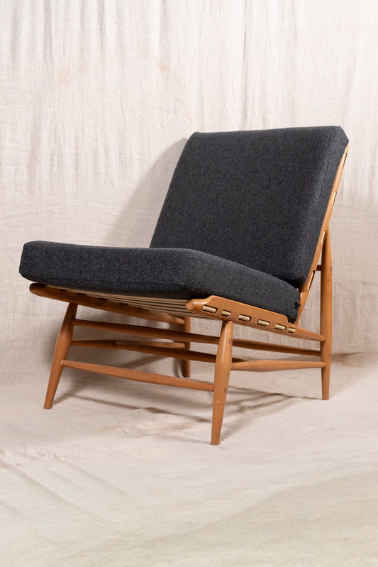 Mid-century modern Ercol Floating lounge chair, model 427, with a solid elm and beech frame and dark grey upholstered cushions.