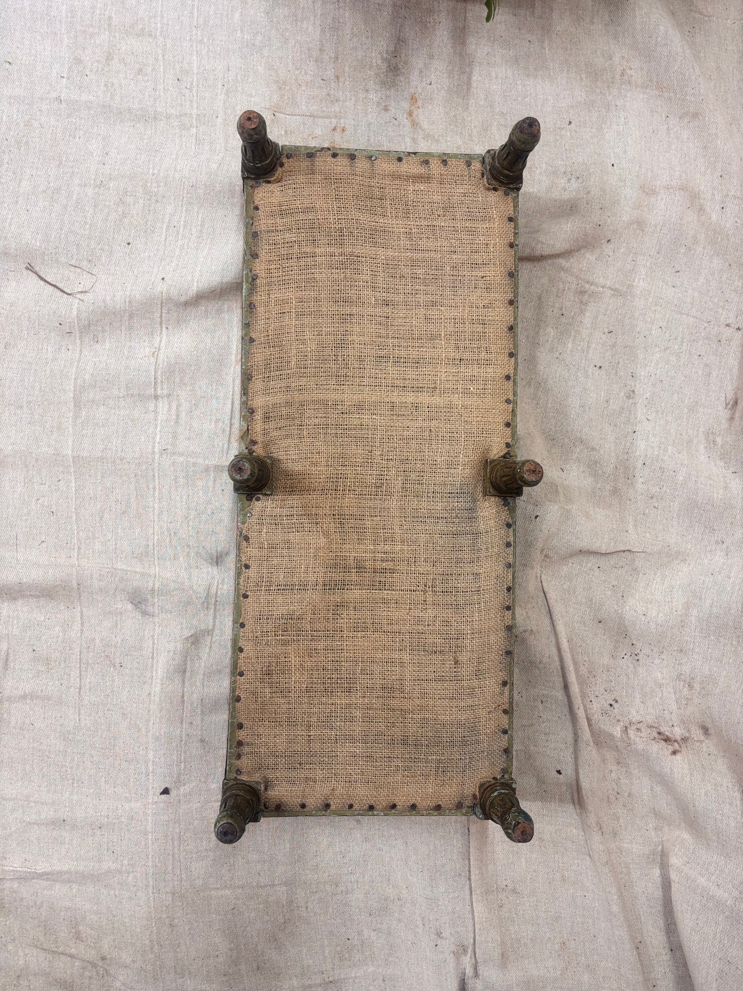 Underside of footstool on a cream background