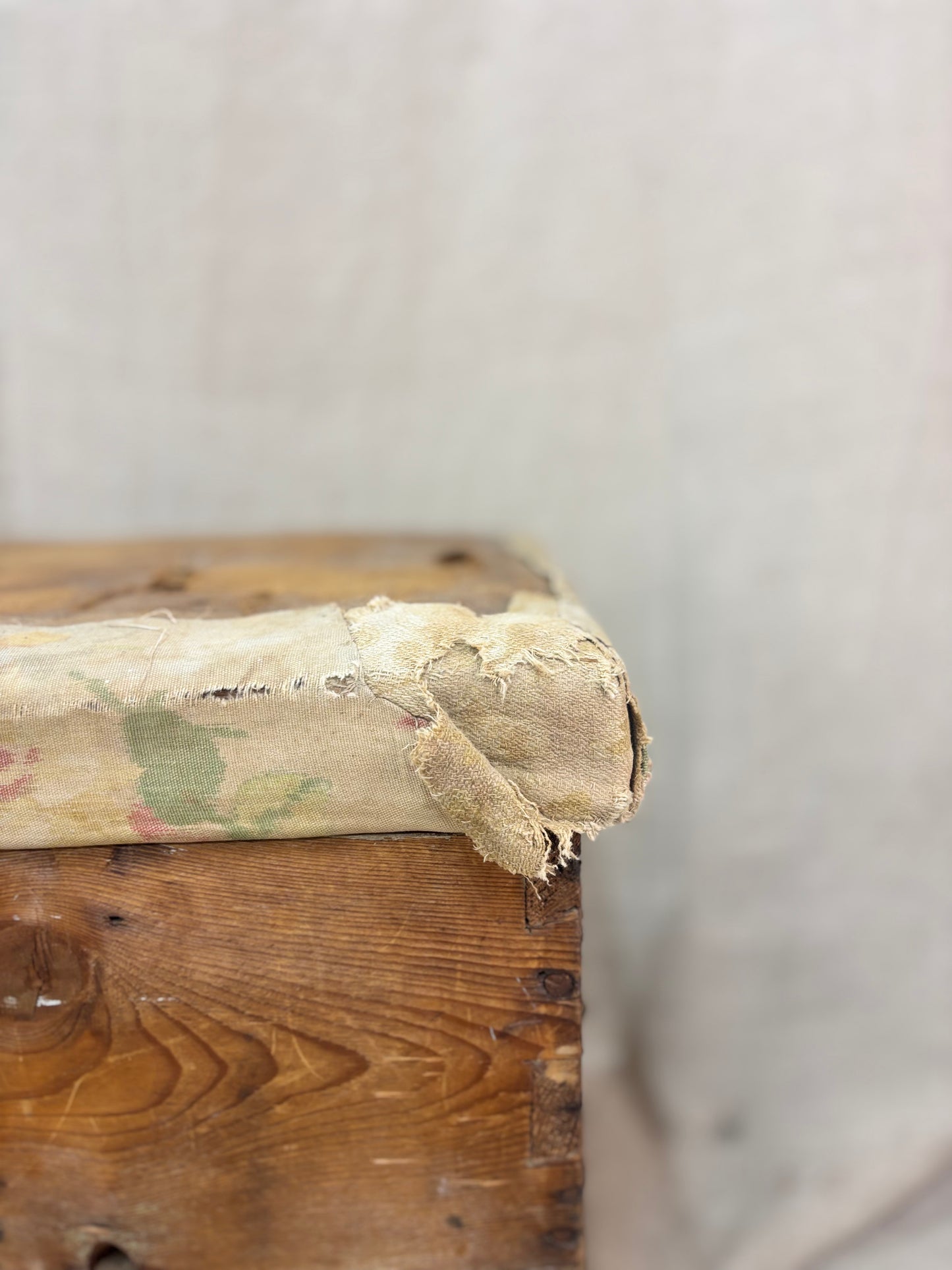 Close-up of an old wooden box with chipped paint on a neutral background
