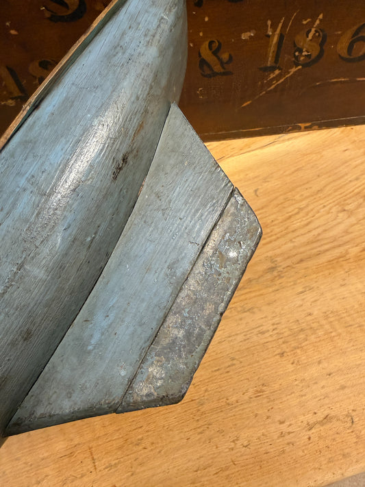 Vintage folk art pond yacht hull with weathered blue-grey paint, lead-weighted keel, original mast stump and matching wooden display stand.