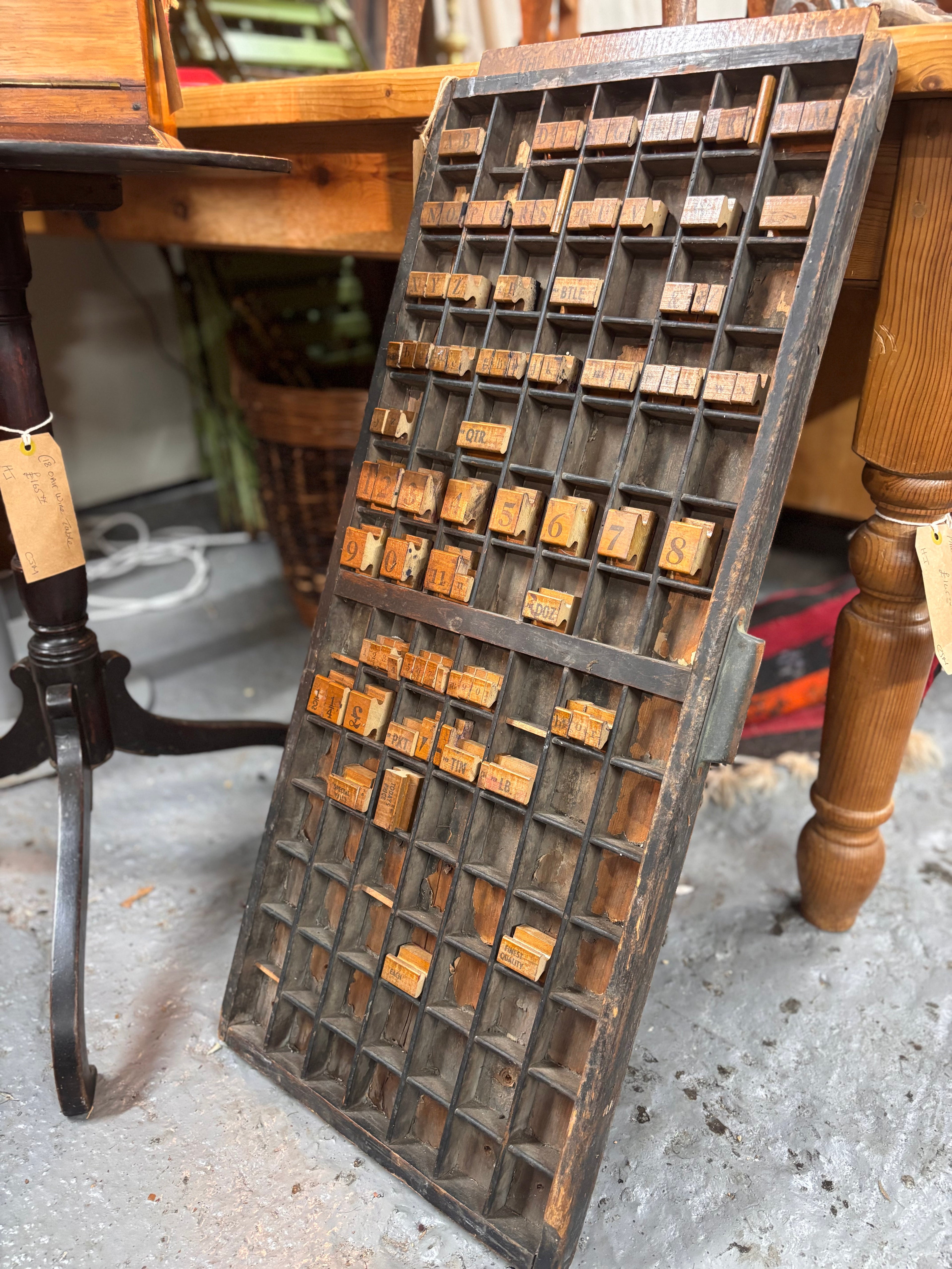 An antique Printers Tray with Shopkeepers Stamps 