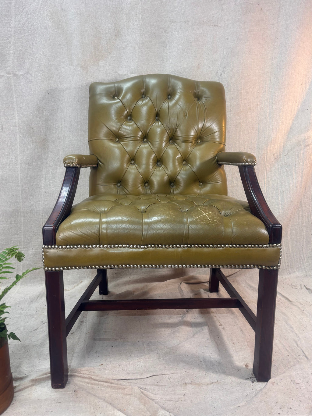 A Green Button Back Armchair