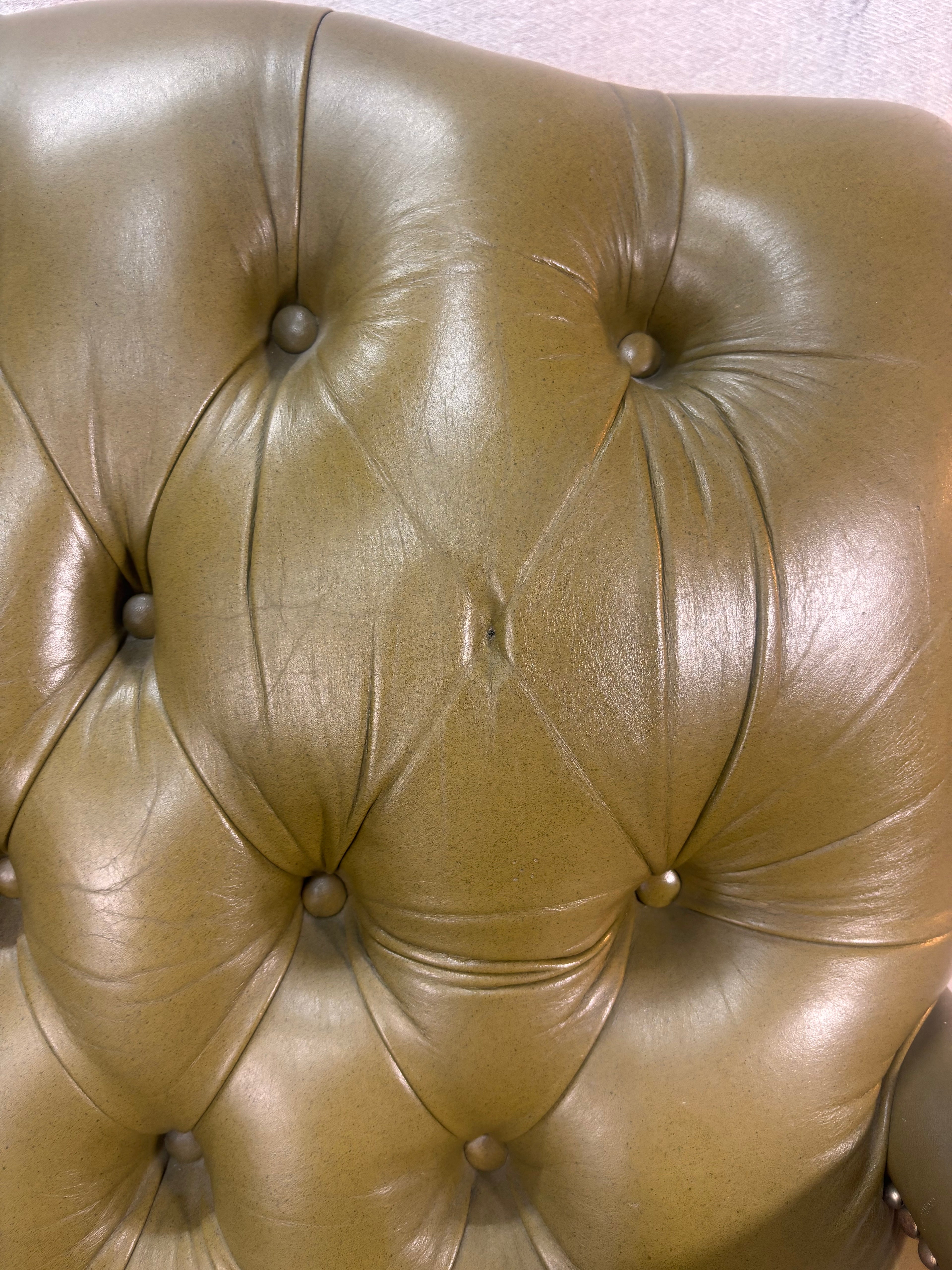 A Green Button Back Armchair