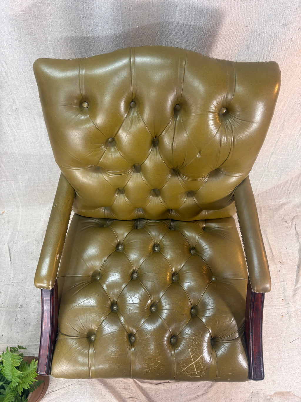 A Green Button Back Armchair