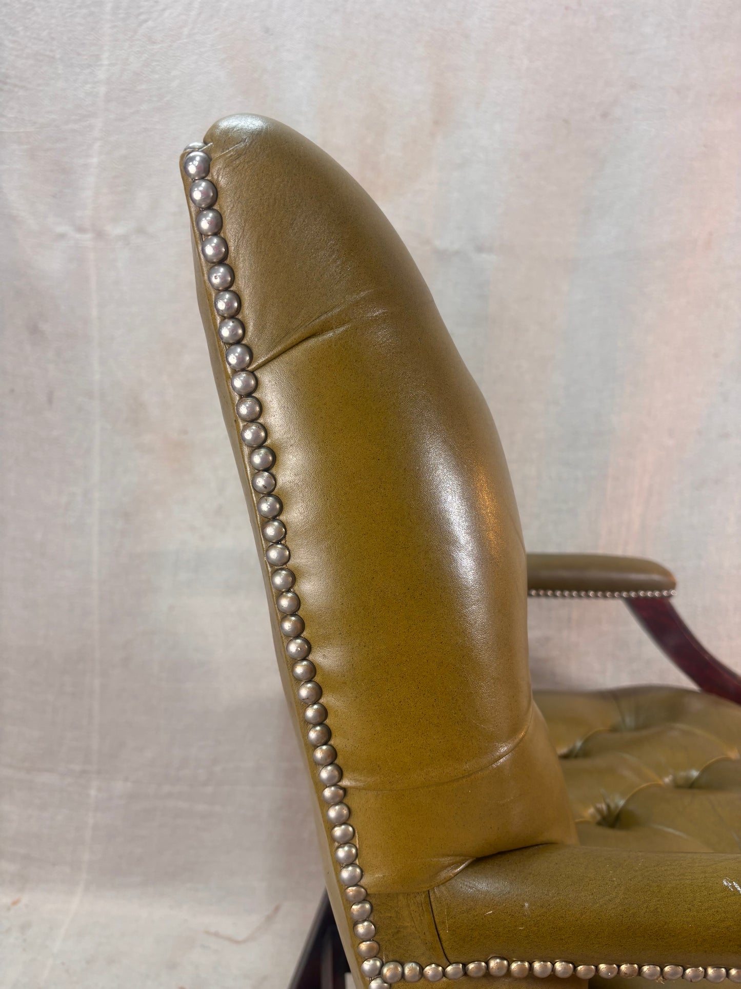 A Green Button Back Armchair