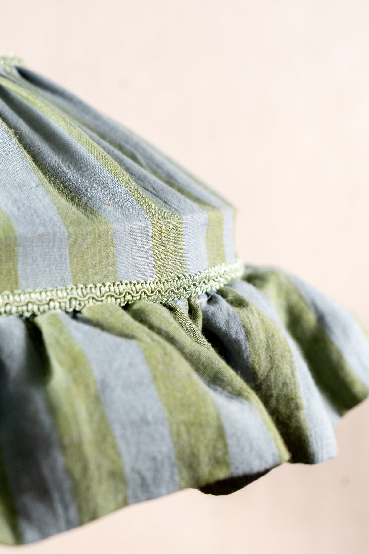 Handmade 12-inch linen carousel shade with sage green and soft blue stripes, vintage trim and pendant fitting. Cosy cottage style.
