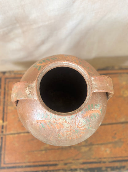 Ceramic vase with decorative patterns on a textured surface