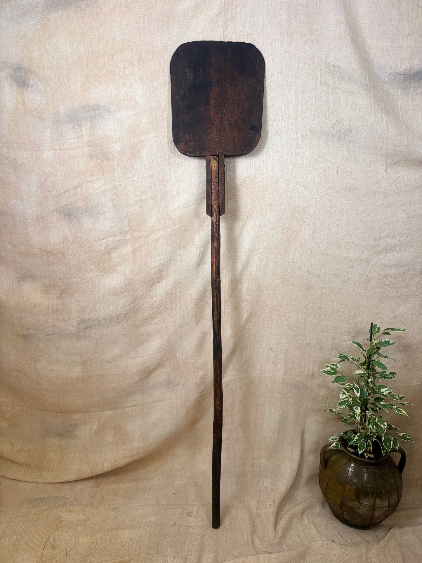 Antique Wooden bakers peel on a textured beige background