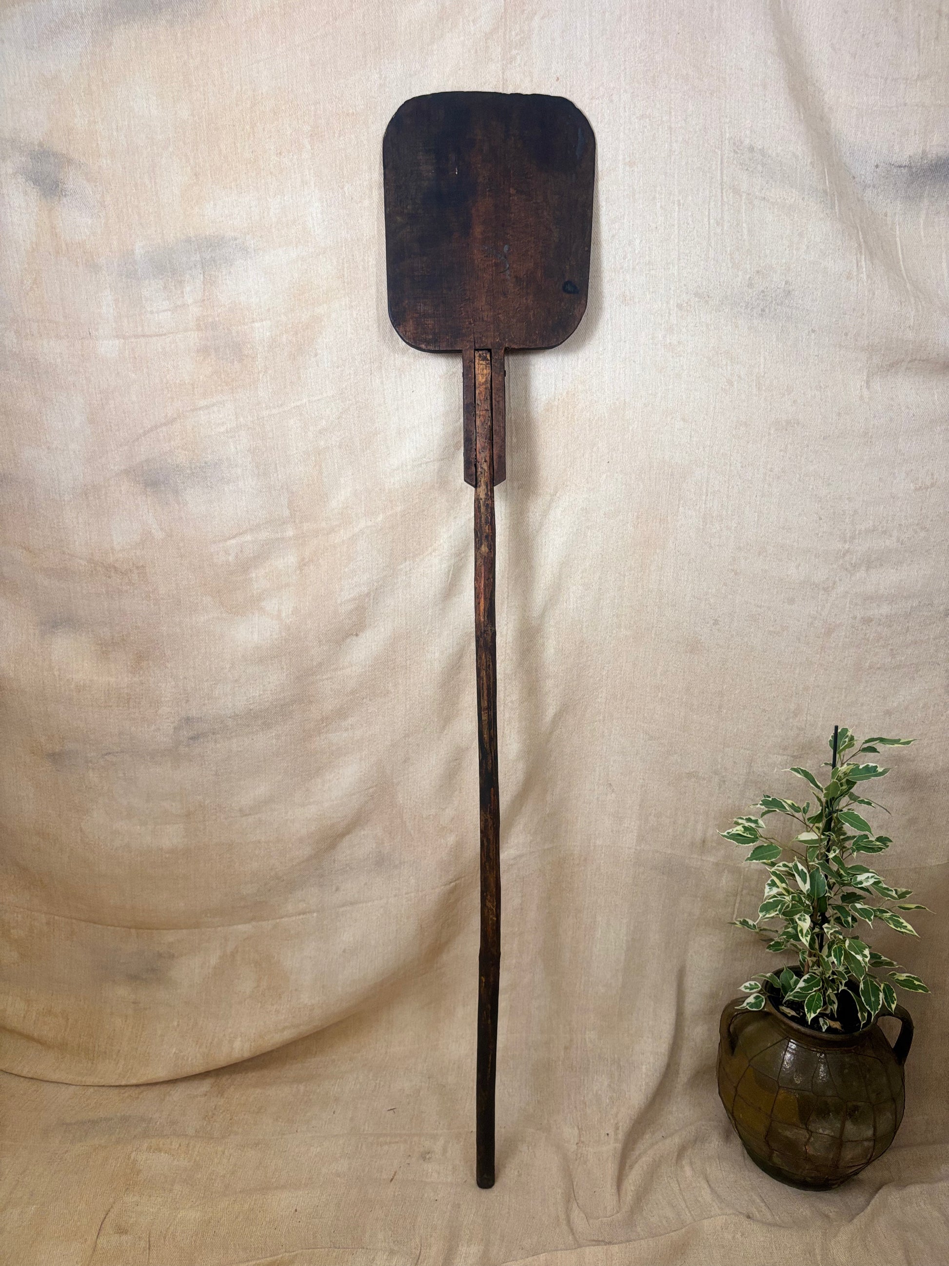 Antique Wooden bakers peel on a textured beige background