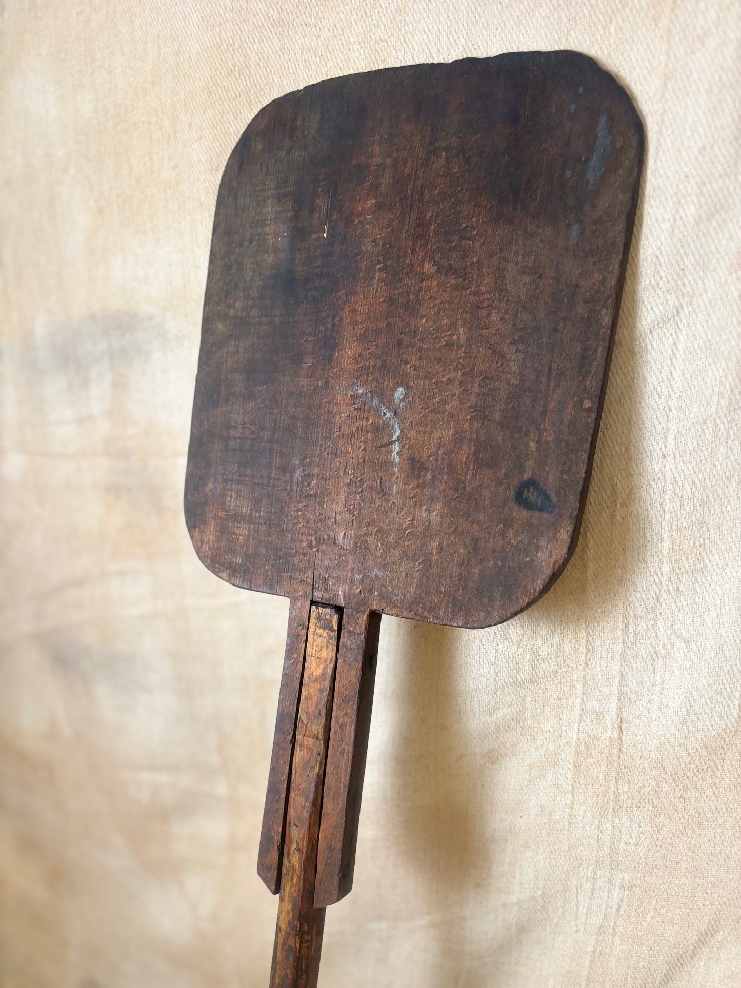 Antique Wooden bakers peel on a textured beige background