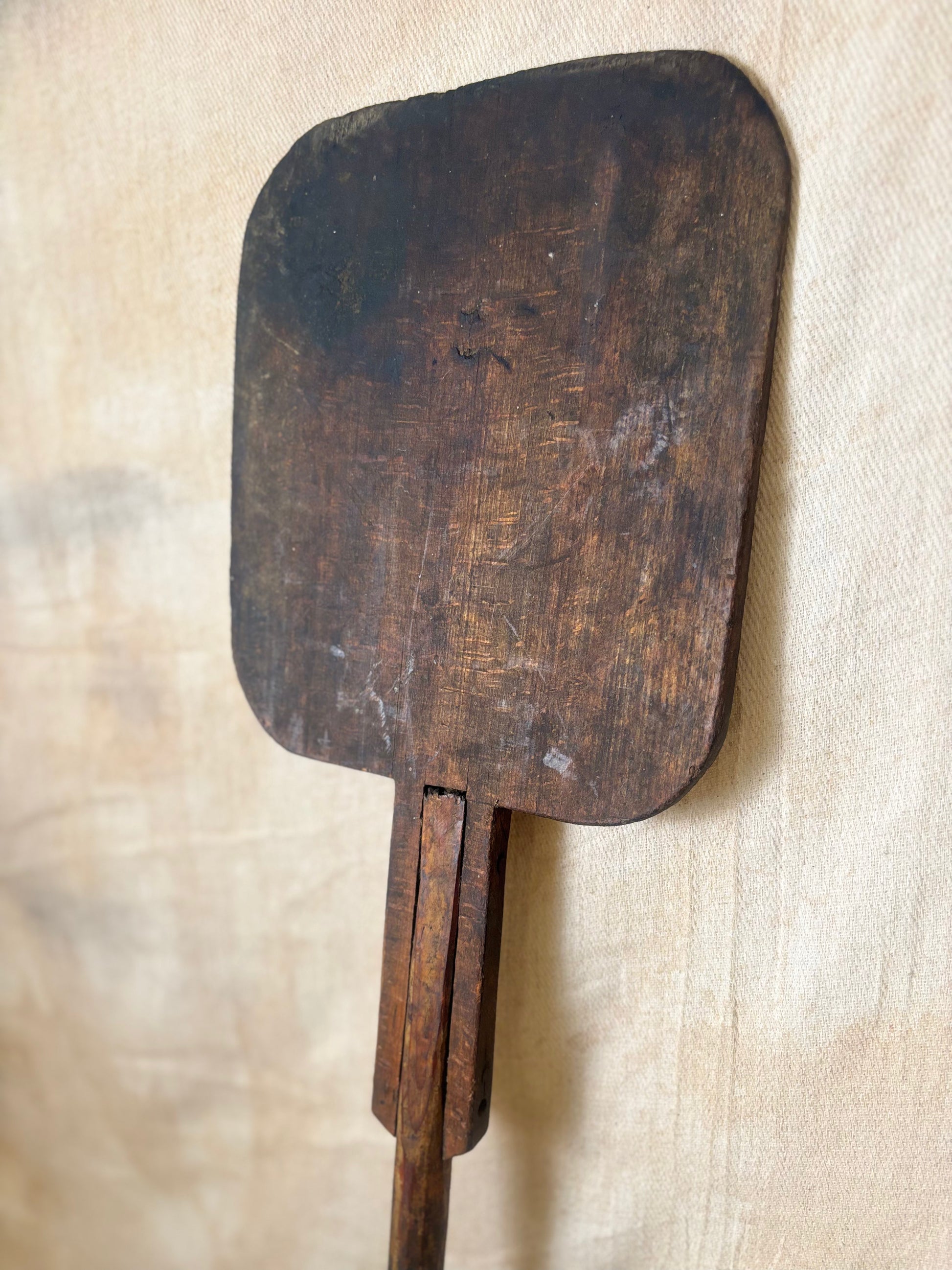 Antique Wooden bakers peel on a textured beige background