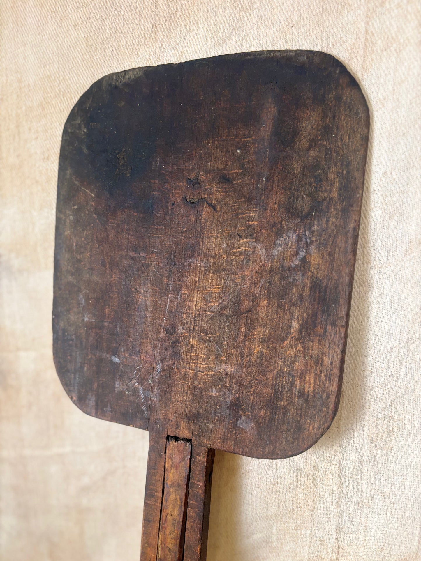Antique Wooden bakers peel on a textured beige background