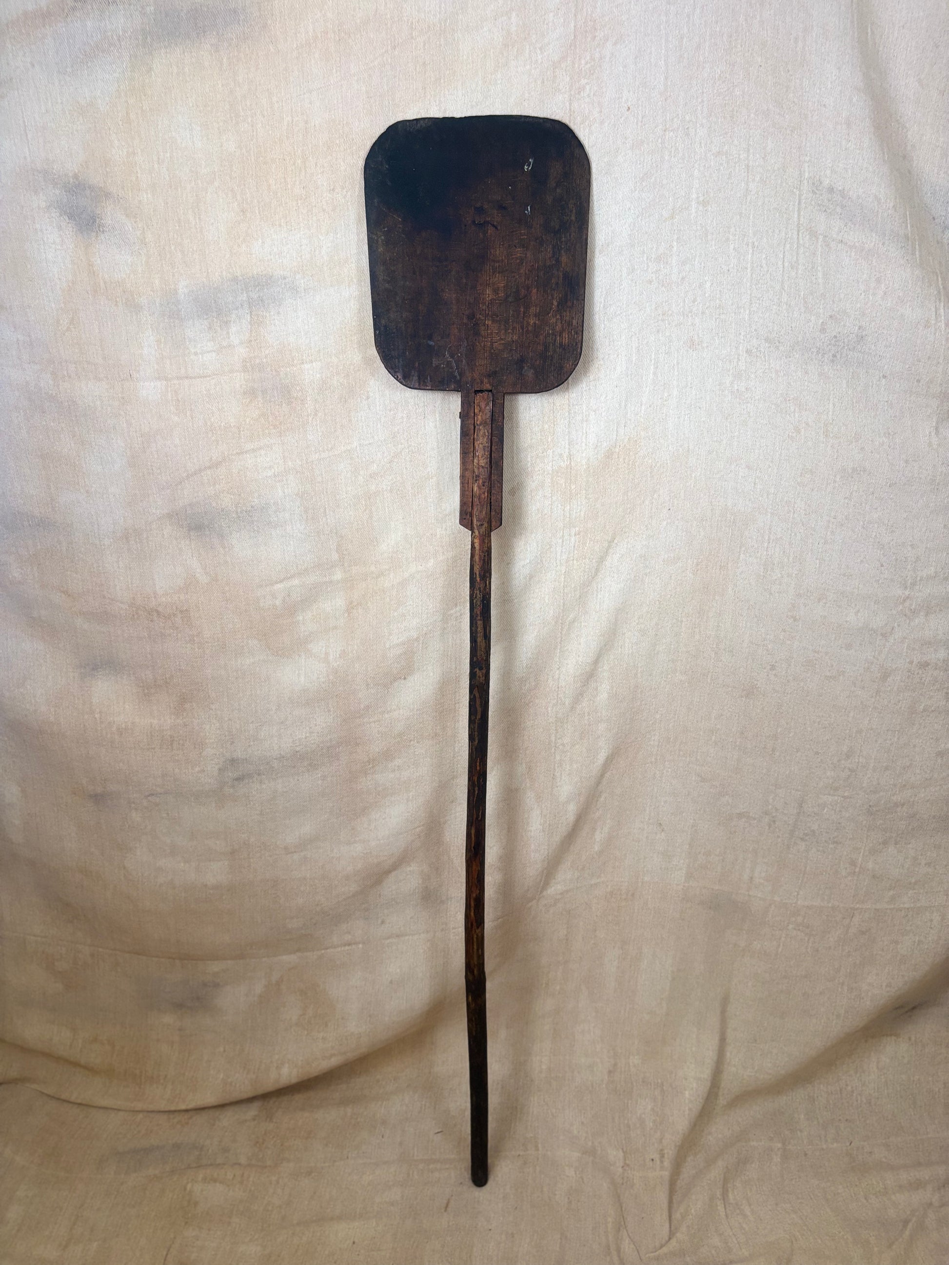 Antique Wooden bakers peel on a textured beige background