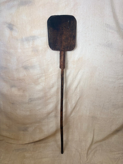 Antique Wooden bakers peel on a textured beige background