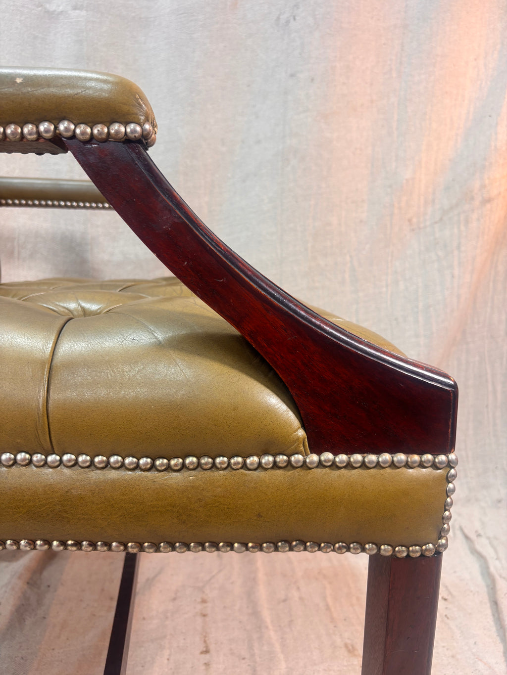 A Green Button Back Armchair