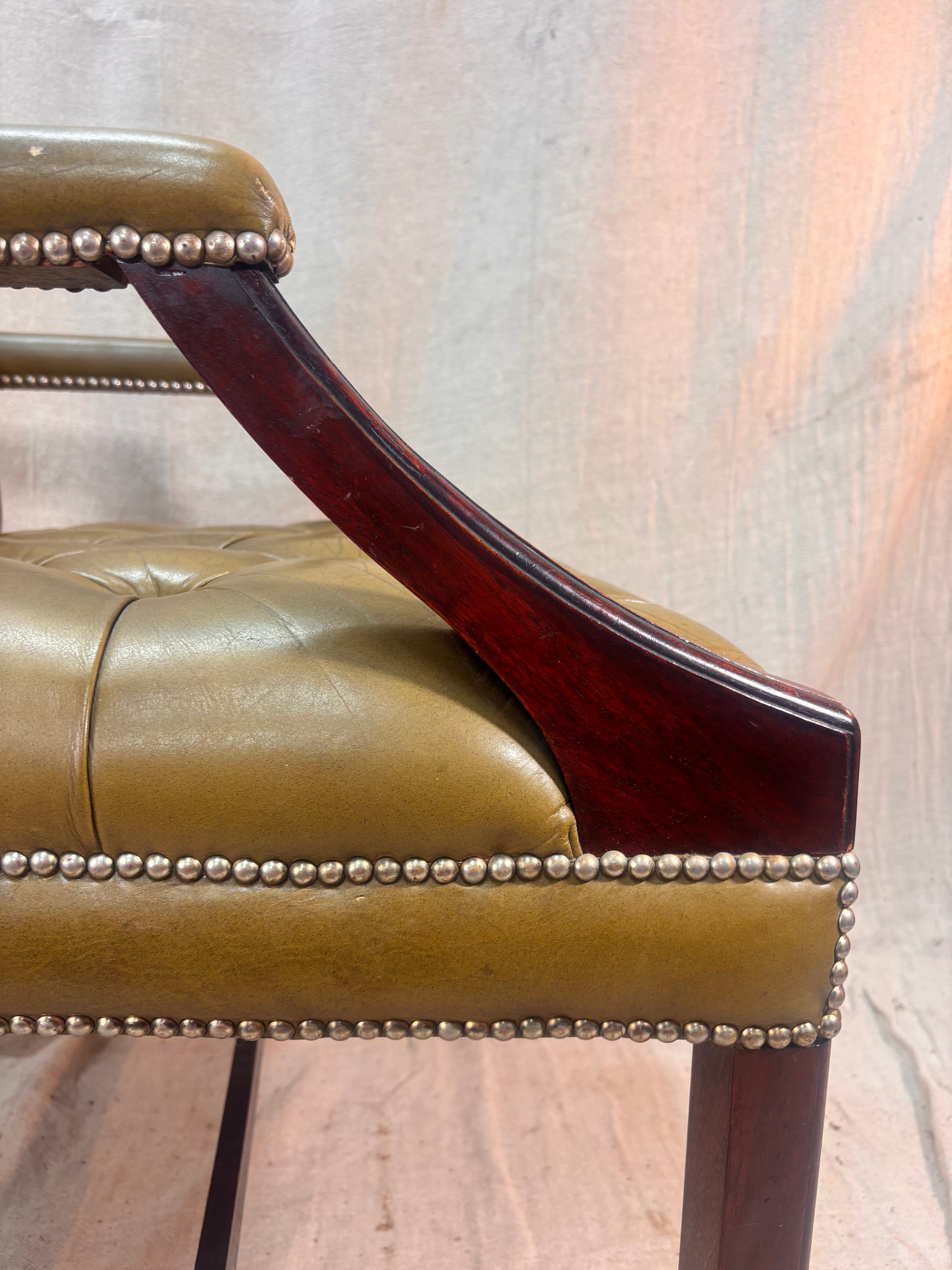 A Green Button Back Armchair