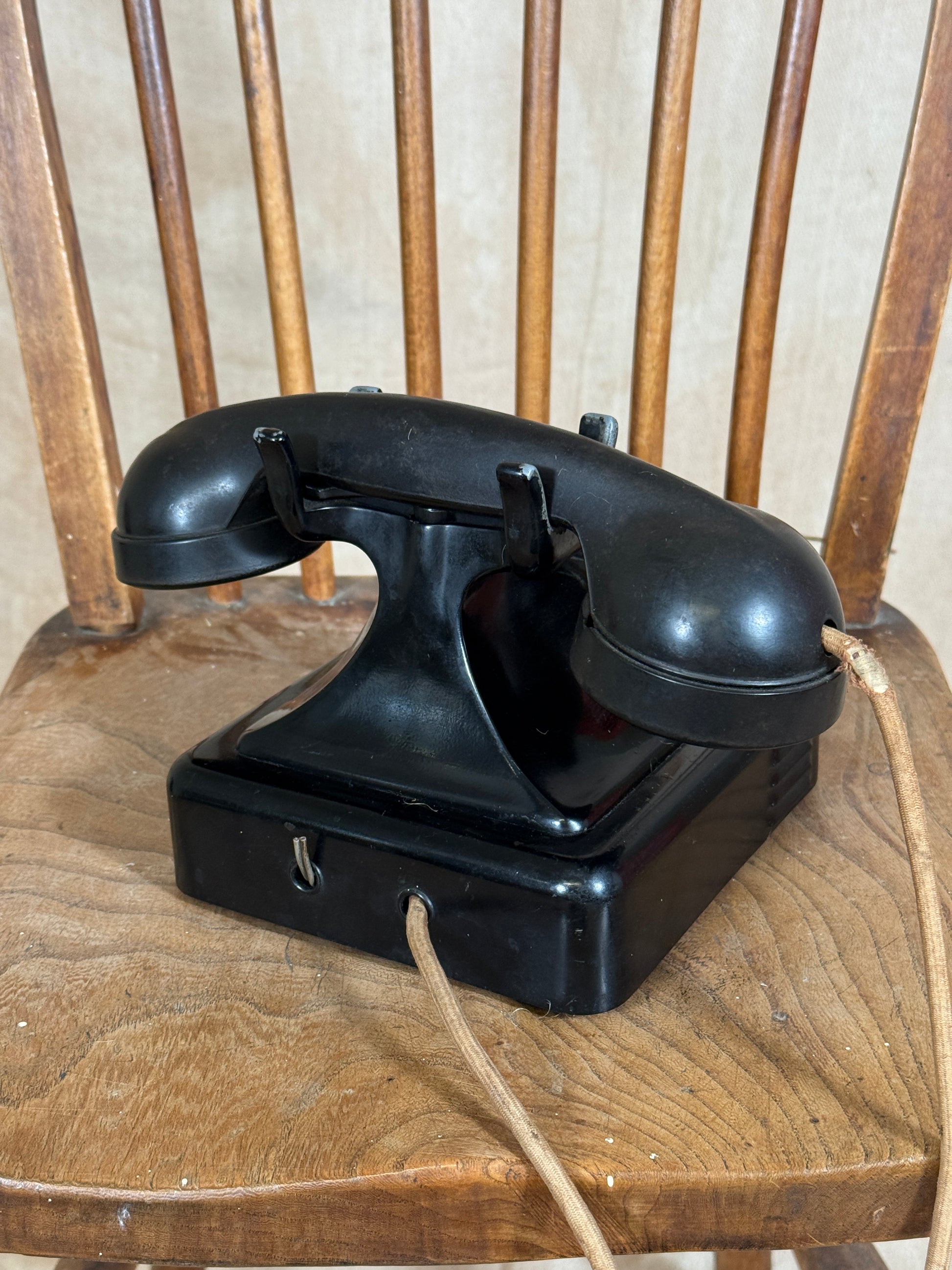 Black metal bracket attached to a wooden surface