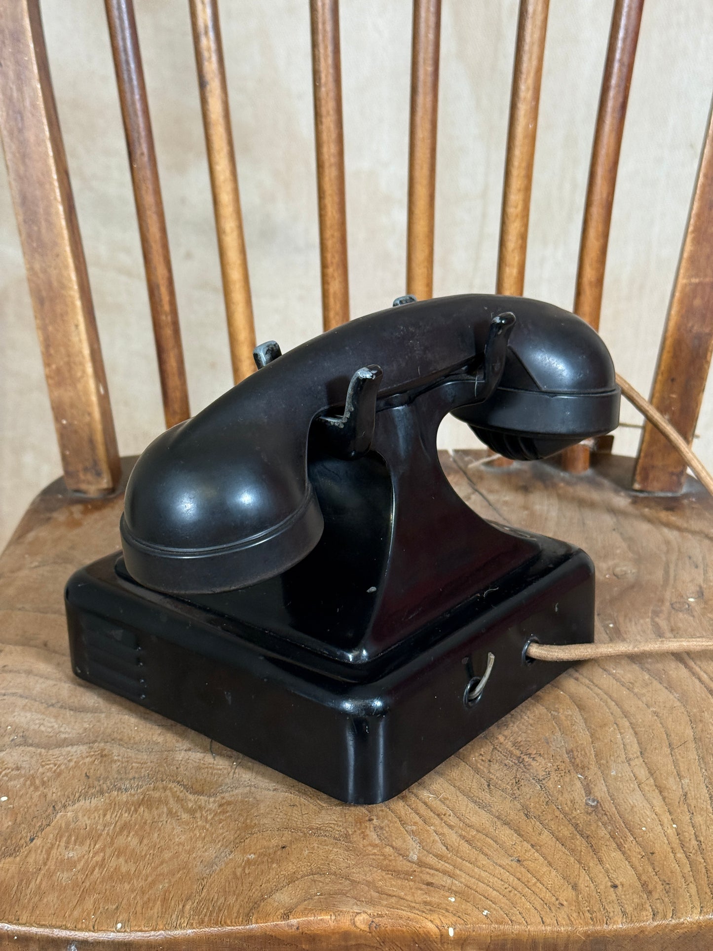 Black wall-mounted device on a wooden surface
