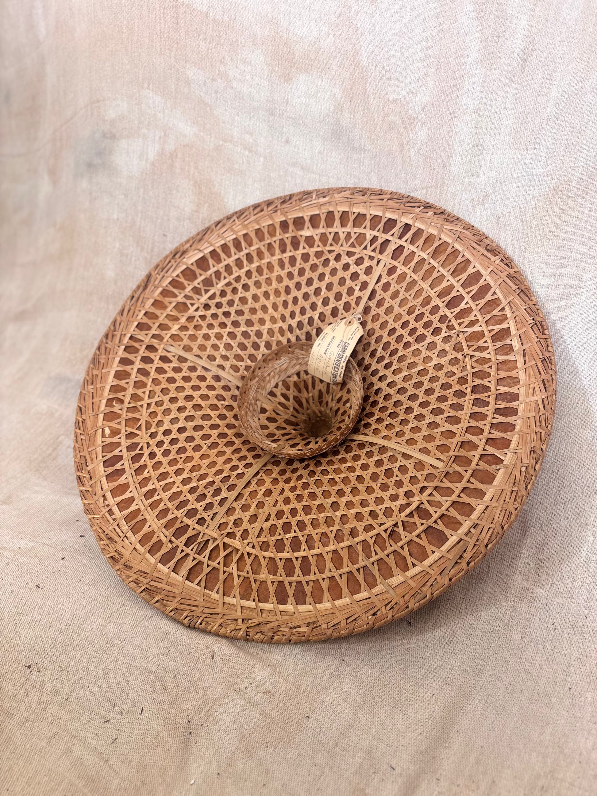 Vintage Asian conical hat with original Royal Air Force cabin identification tag attached, woven natural fibre hat with RAF Brize Norton luggage label.