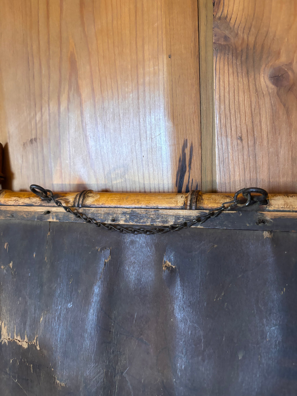 Back of a antique mirror with hanging chain