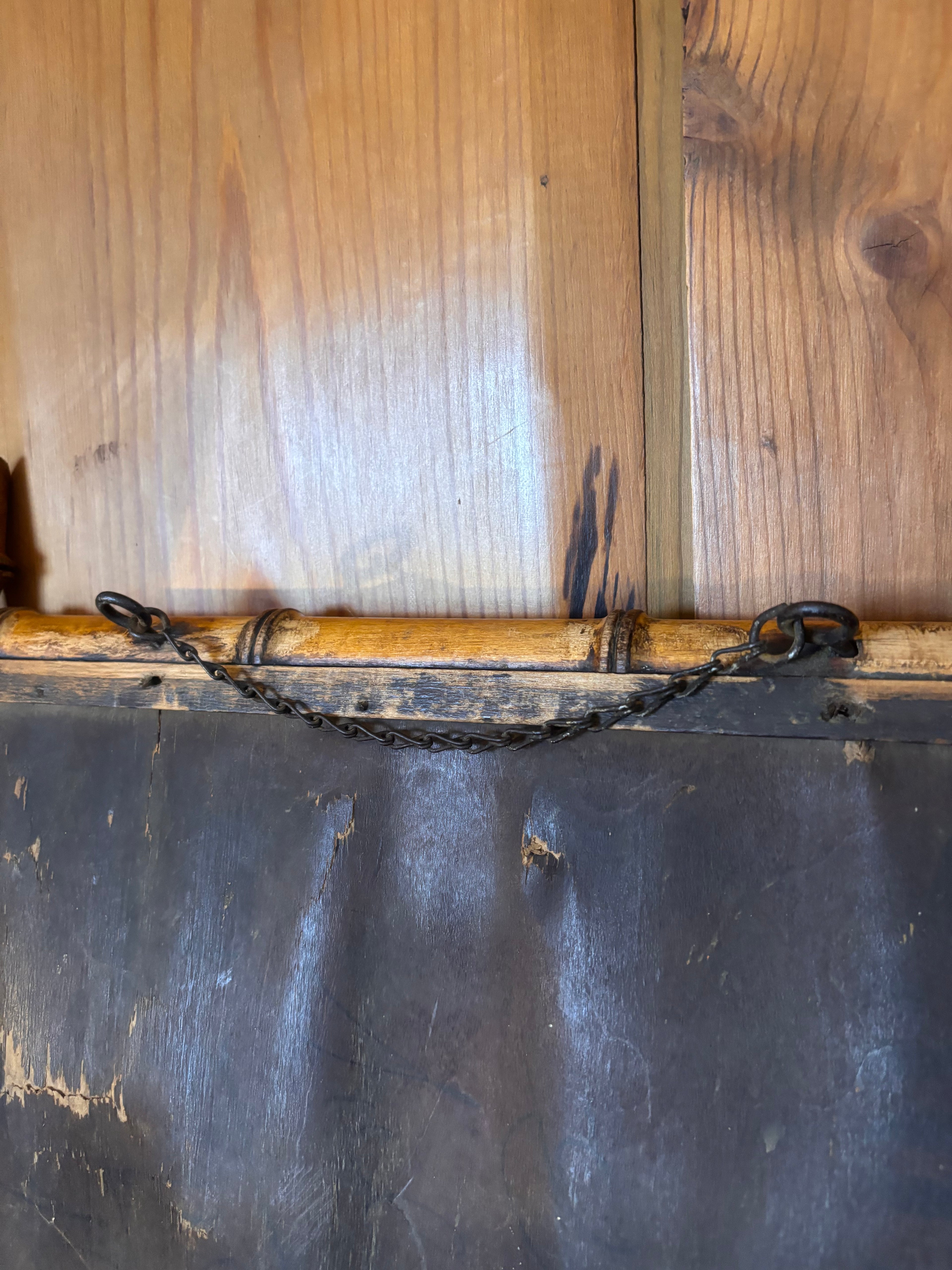 Back of a antique mirror with hanging chain