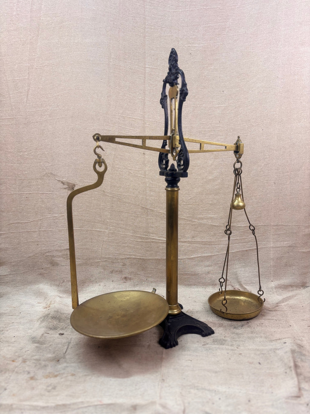 19th century W & T Avery Patent Agate Balance beam scale in brass and cast iron, photographed against a cream backdrop.