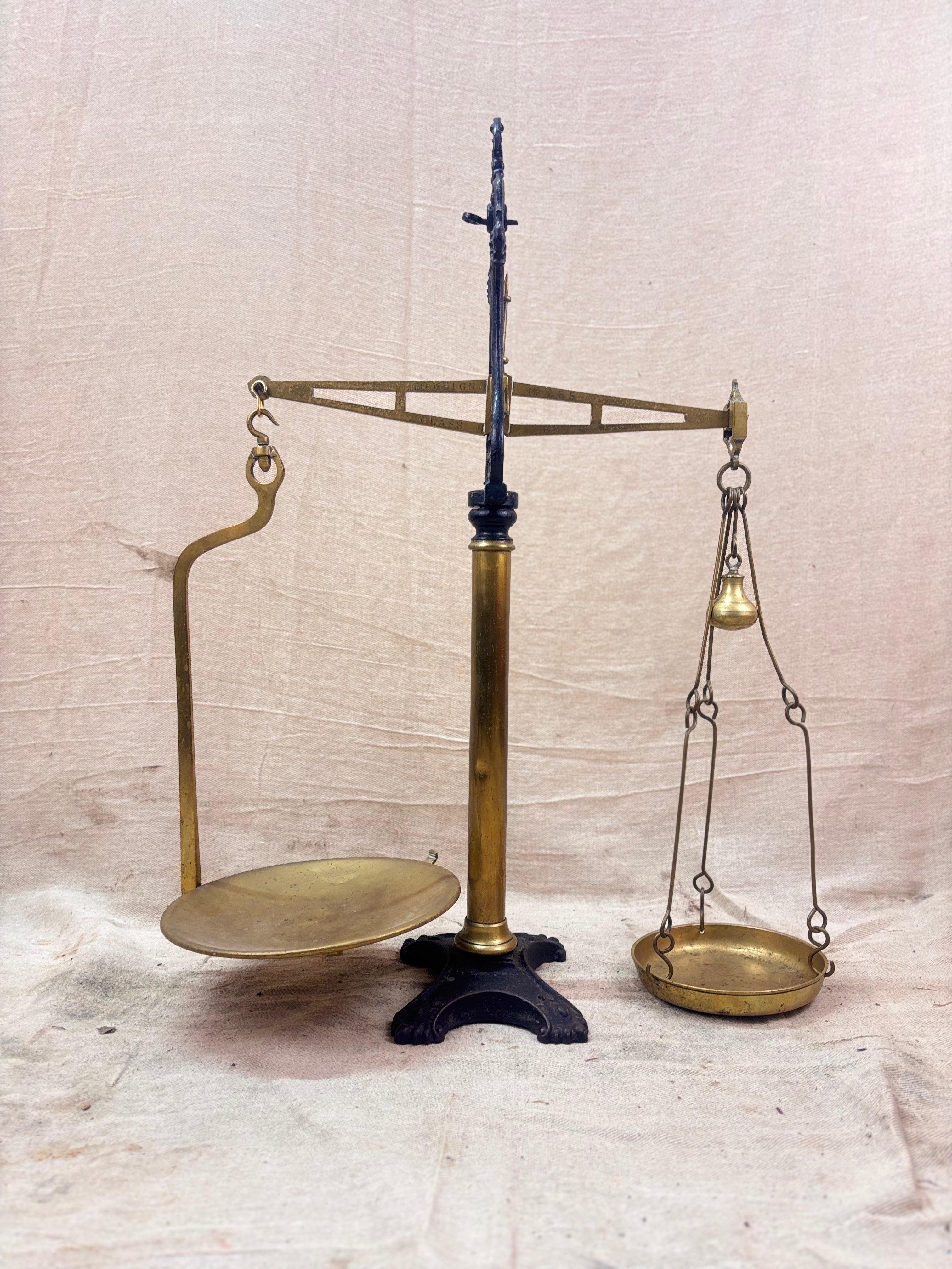 19th century W & T Avery Patent Agate Balance beam scale in brass and cast iron, photographed against a cream backdrop.