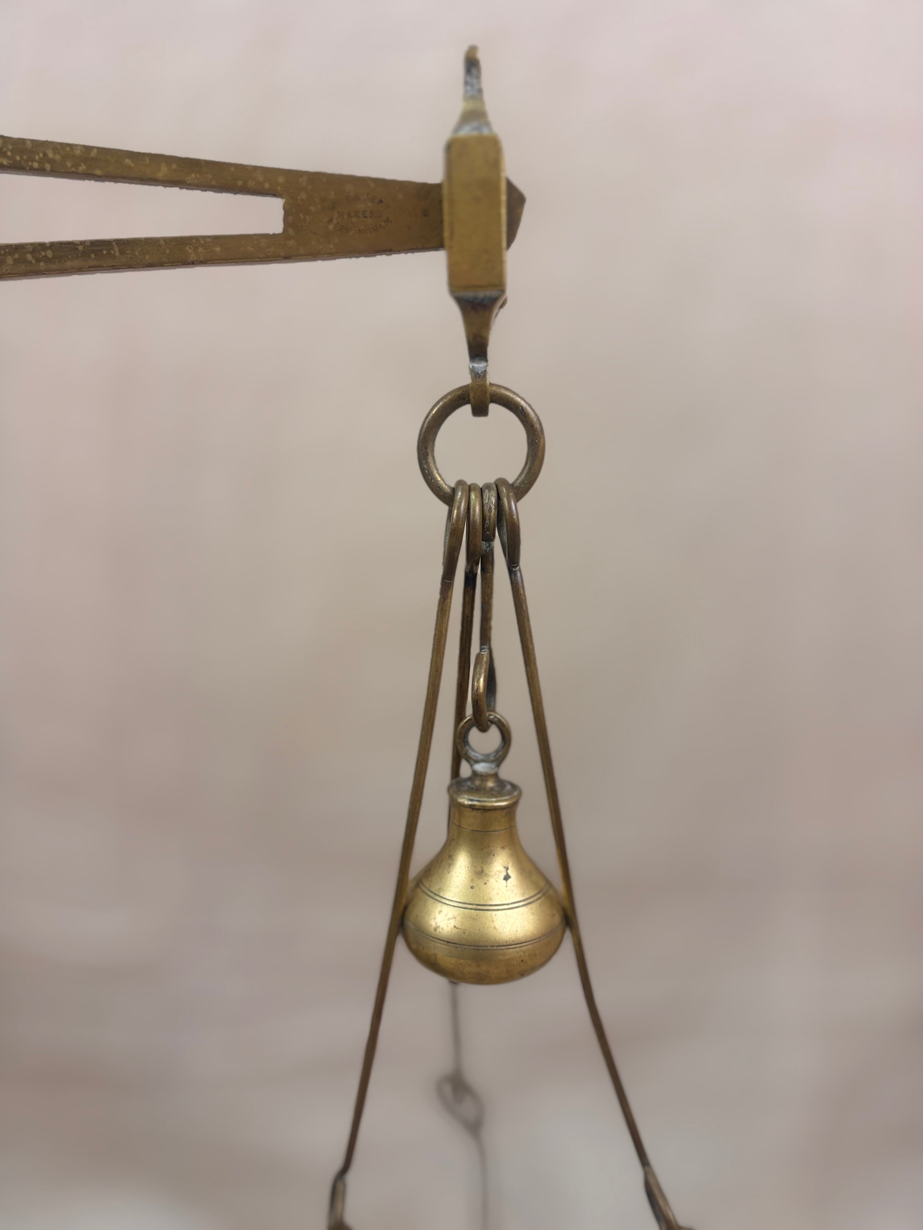 19th century W & T Avery Patent Agate Balance beam scale in brass and cast iron, photographed against a cream backdrop.