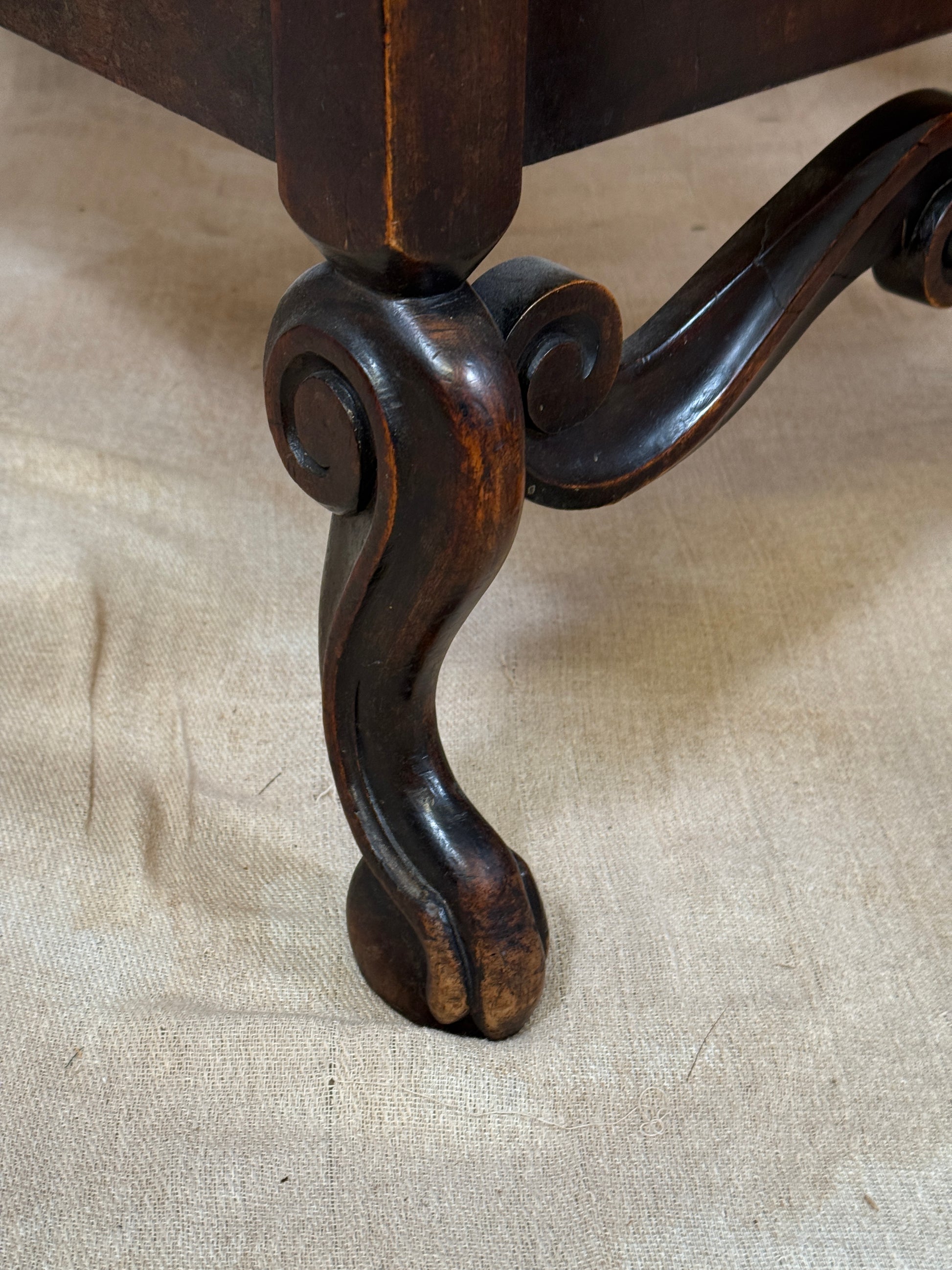 Antique Bergère style cane armchair and matching footstool with dark carved wooden frames and woven cane panels.