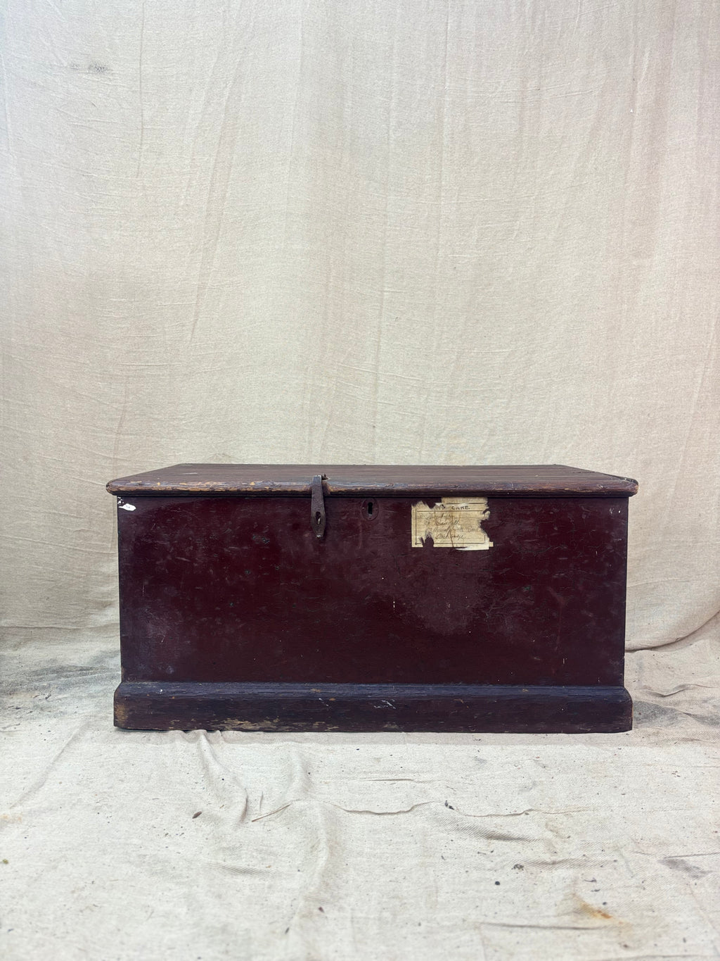 Antique wooden trunk on a textured beige background