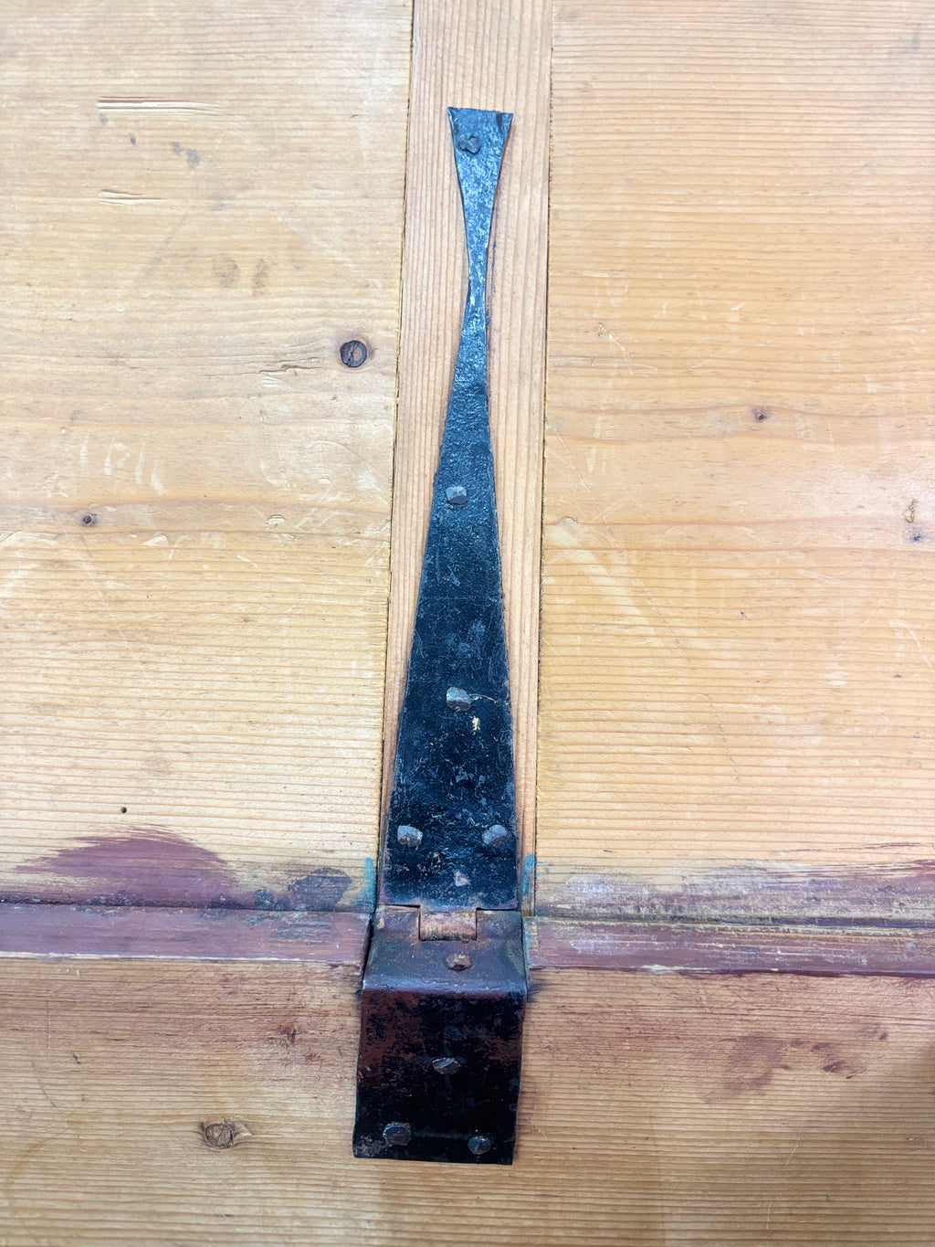 Metal hinge on a wooden trunk