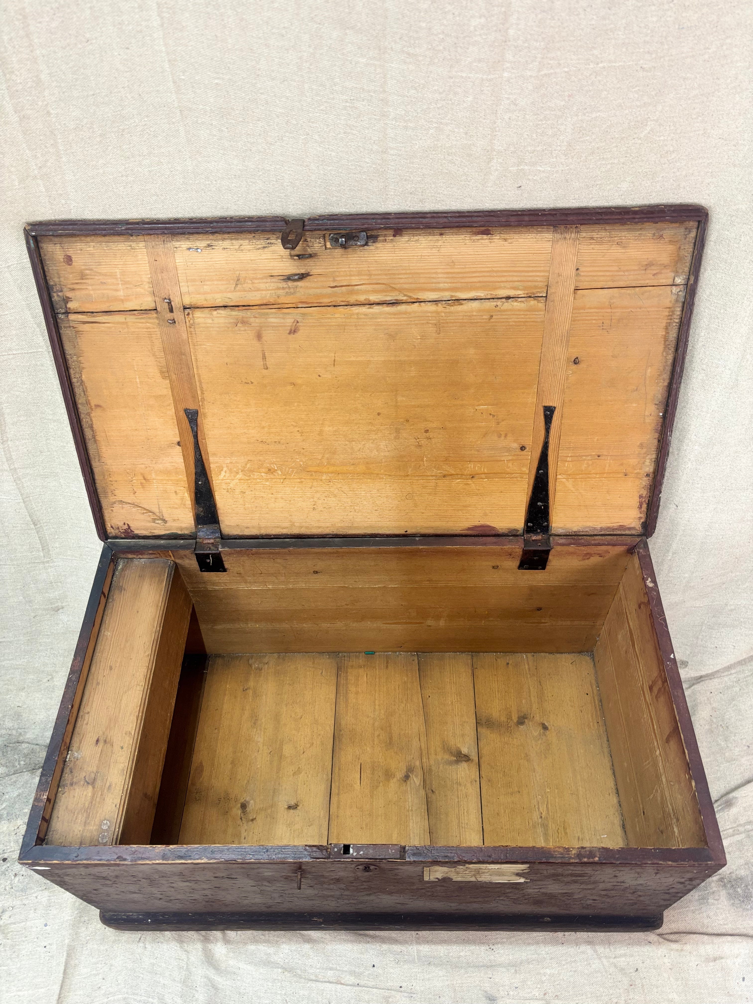 Antique Wooden trunk with a hinged lid on a textured surface
