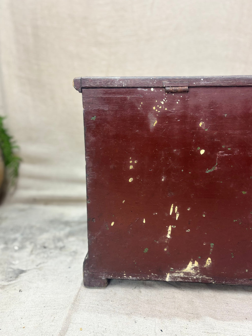 Vintage wooden trunk with peeling paint on a stone surface