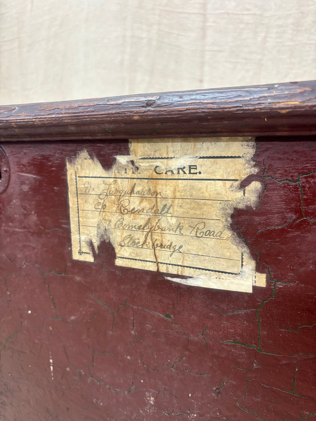 Antique wooden box with a label on a beige background