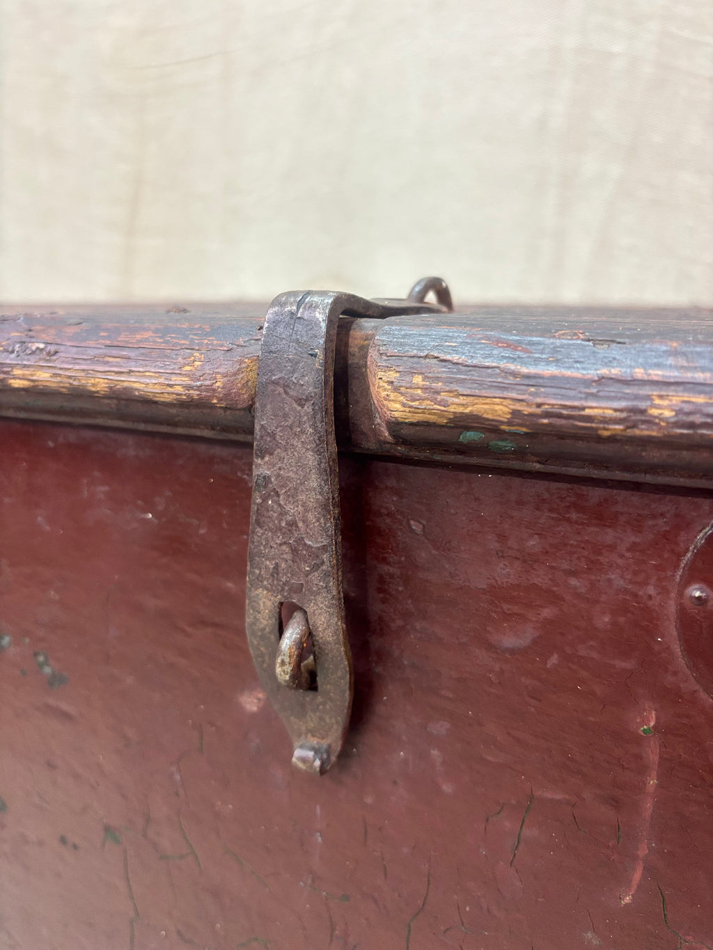 Close-up of an old wooden trunk with a metal handle and lid.