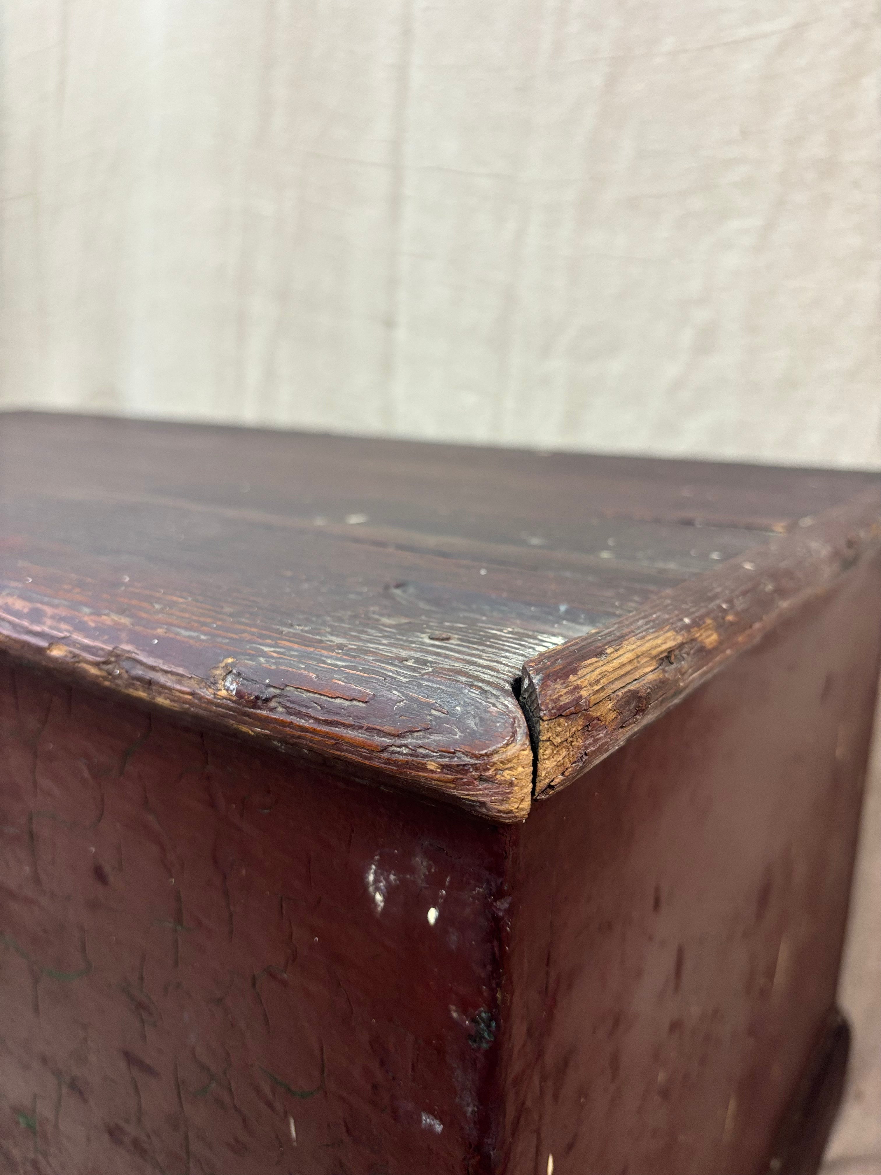 Close-up of a worn wooden surface with a beige background