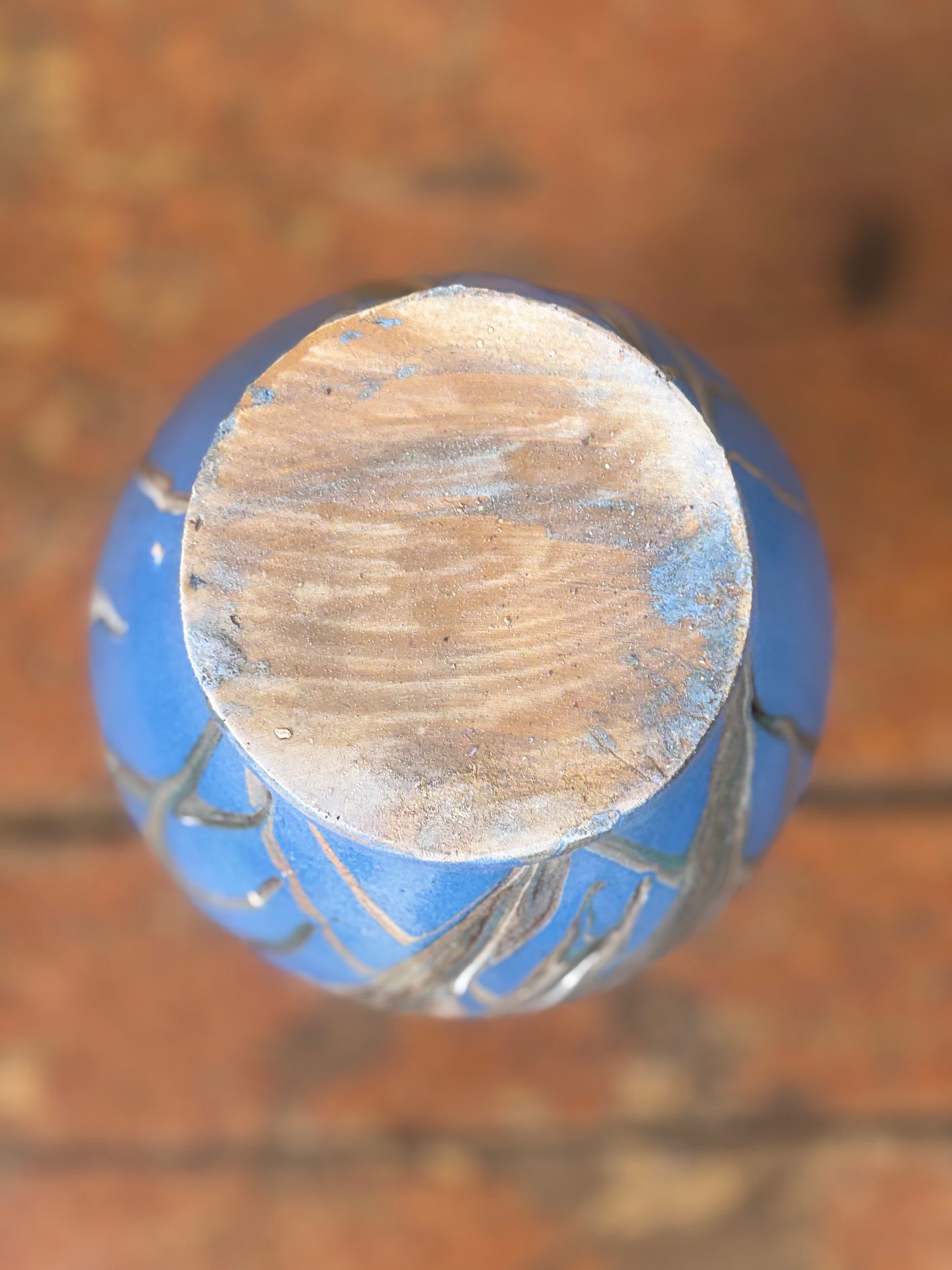 Close-up of a blue and brown cylindrical object on a blurred background