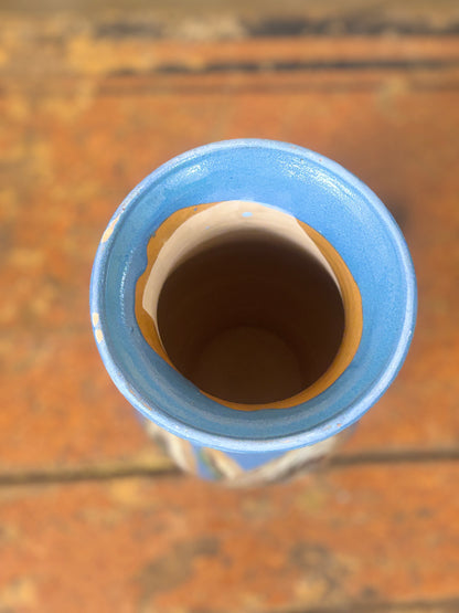 Close-up of a blue ceramic vase on a wooden surface