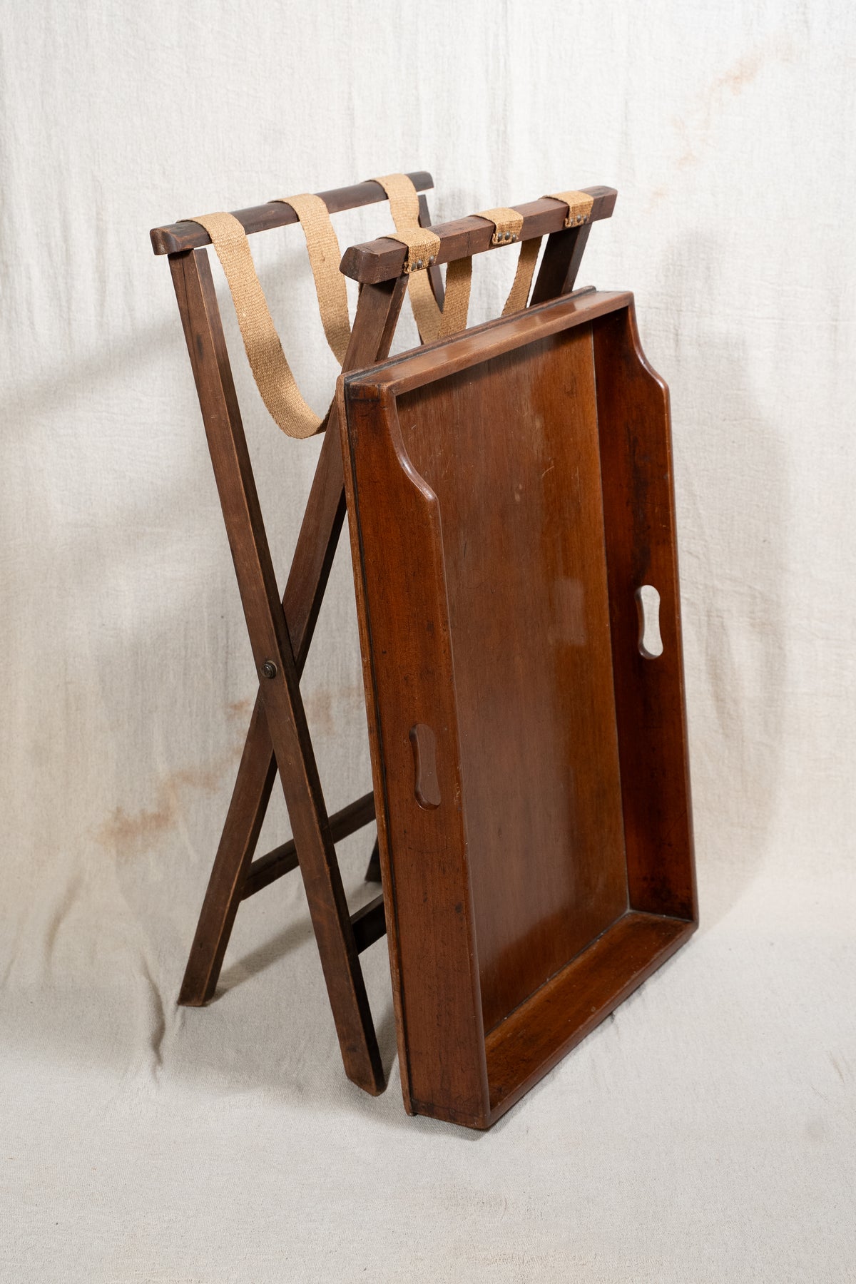Classic wooden butler's tray with raised gallery, pierced carrying handles and folding X-frame stand. A versatile serving and occasional table.