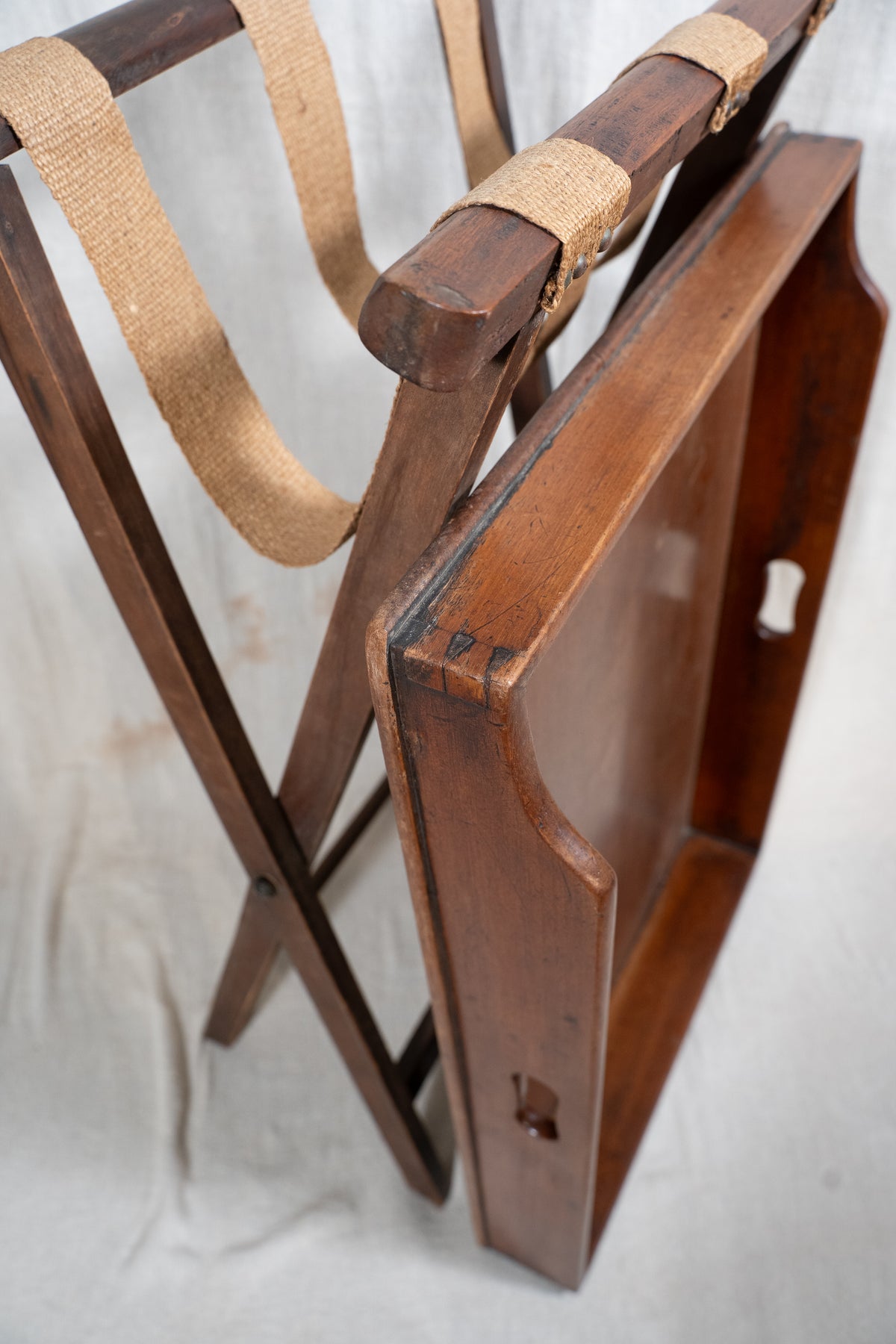 Classic wooden butler's tray with raised gallery, pierced carrying handles and folding X-frame stand. A versatile serving and occasional table.