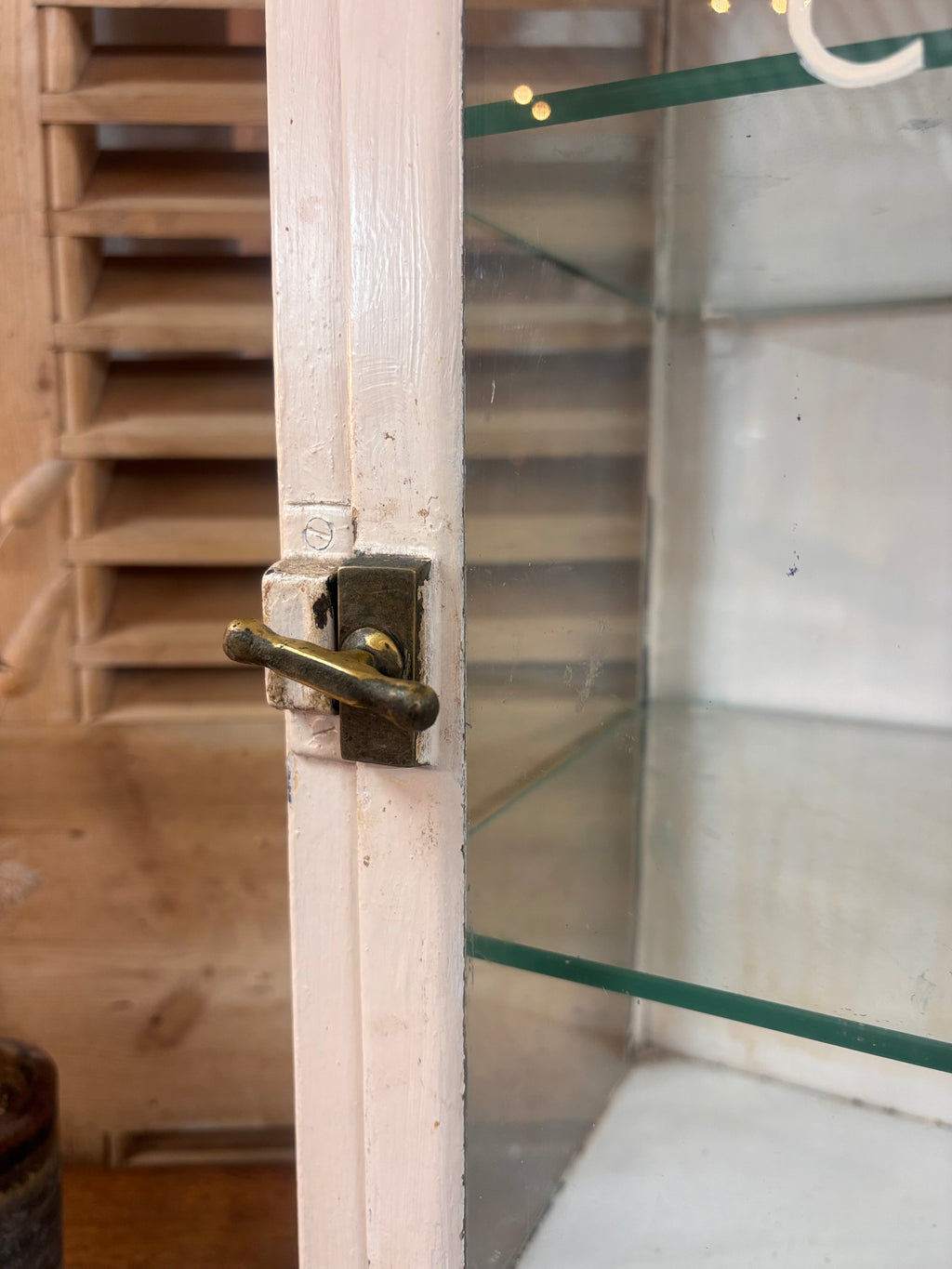 White painted metal Cadburys chocolate display cabinet with glass front, original lettering and aged patina.