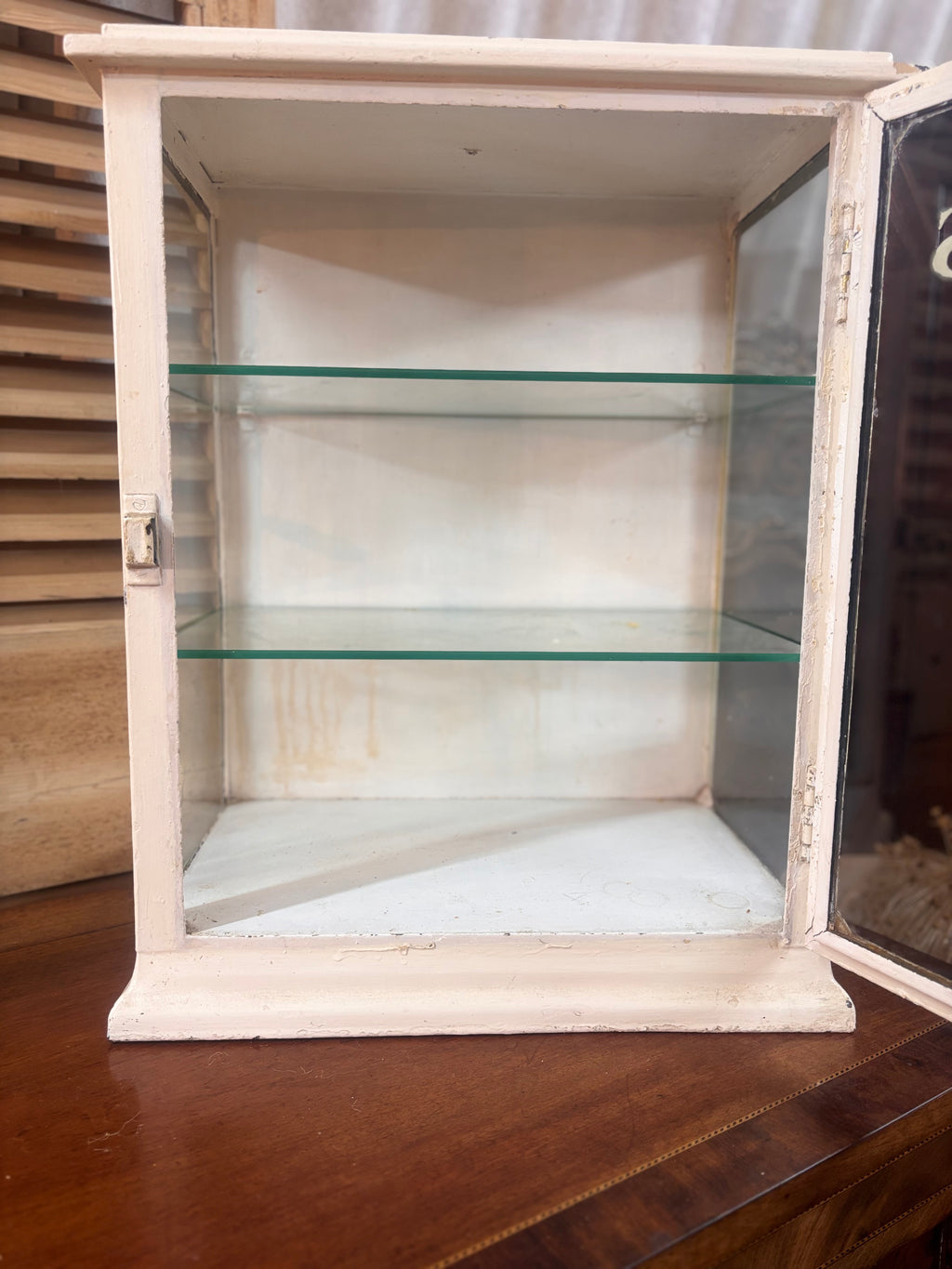 White painted metal Cadburys chocolate display cabinet with glass front, original lettering and aged patina.