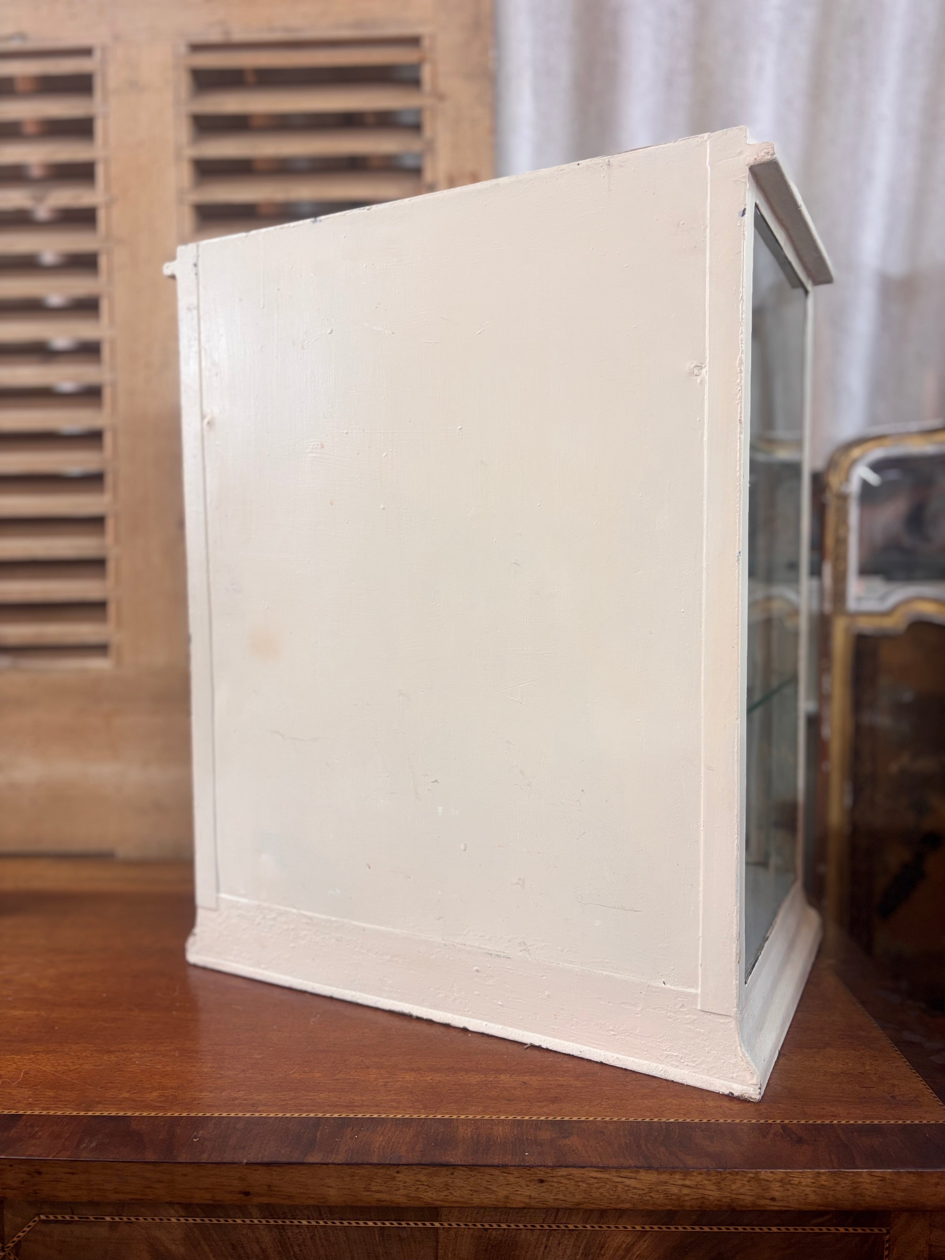 White painted metal Cadburys chocolate display cabinet with glass front, original lettering and aged patina.