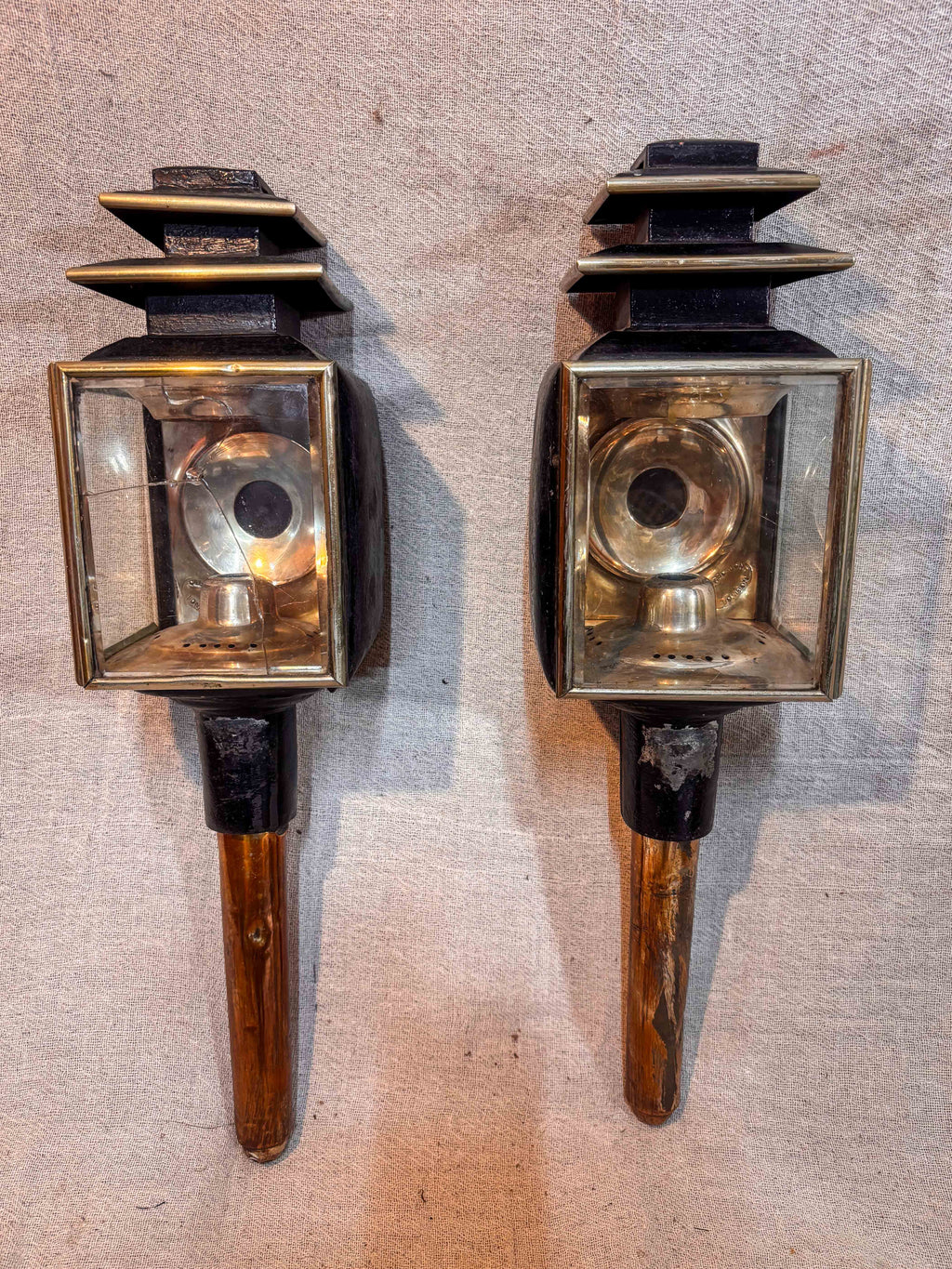 Pair of Antique Carriage lamps on a textured beige background 