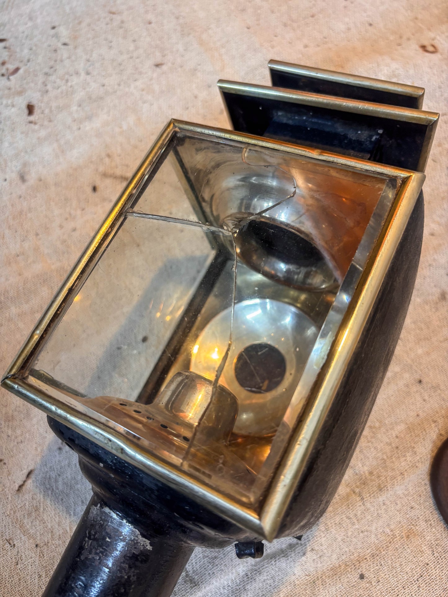 antique glazed carriage lamp on a textured surface