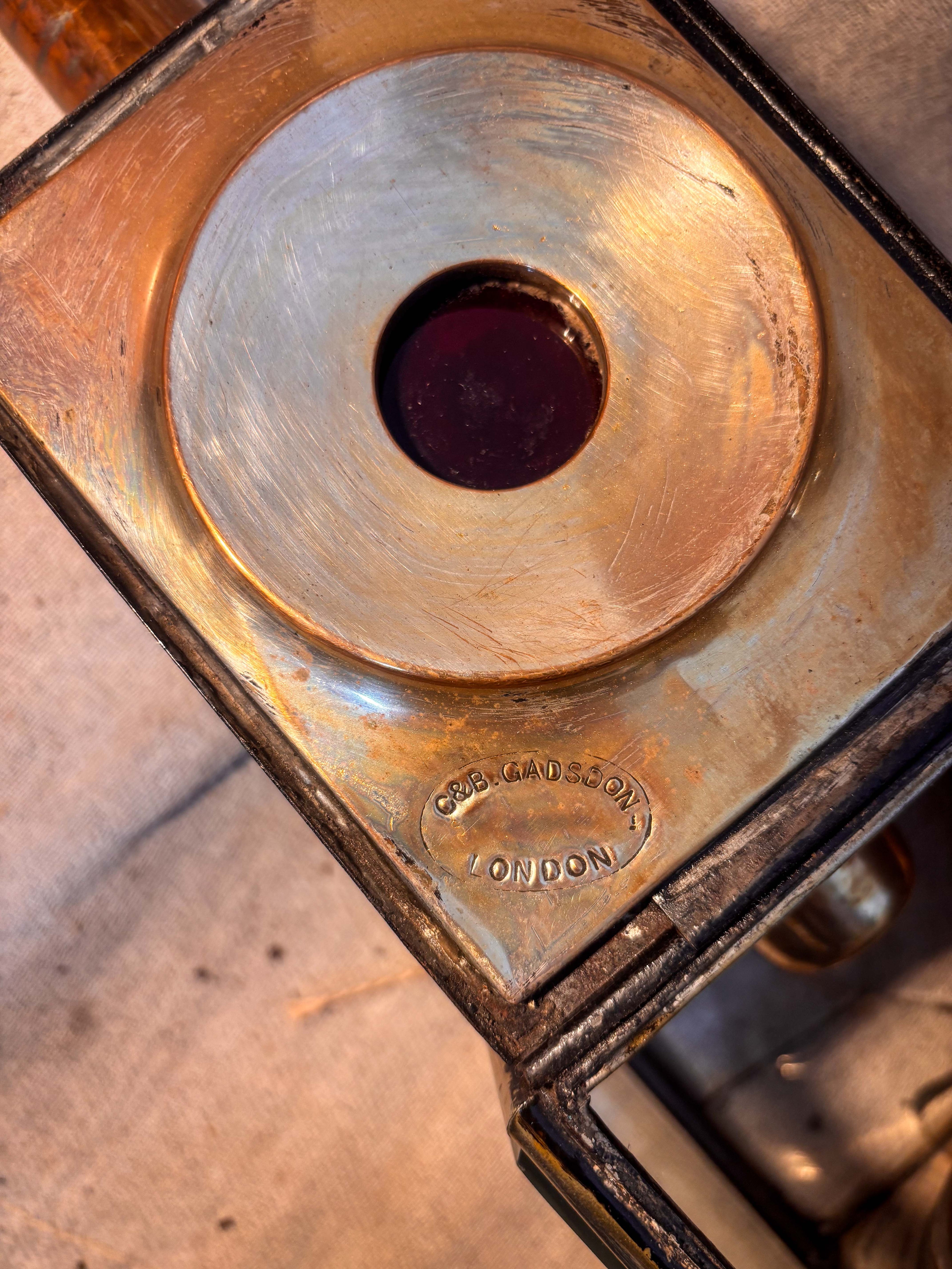 Close-up of an antique carriage lamp interior ith makers mark. 