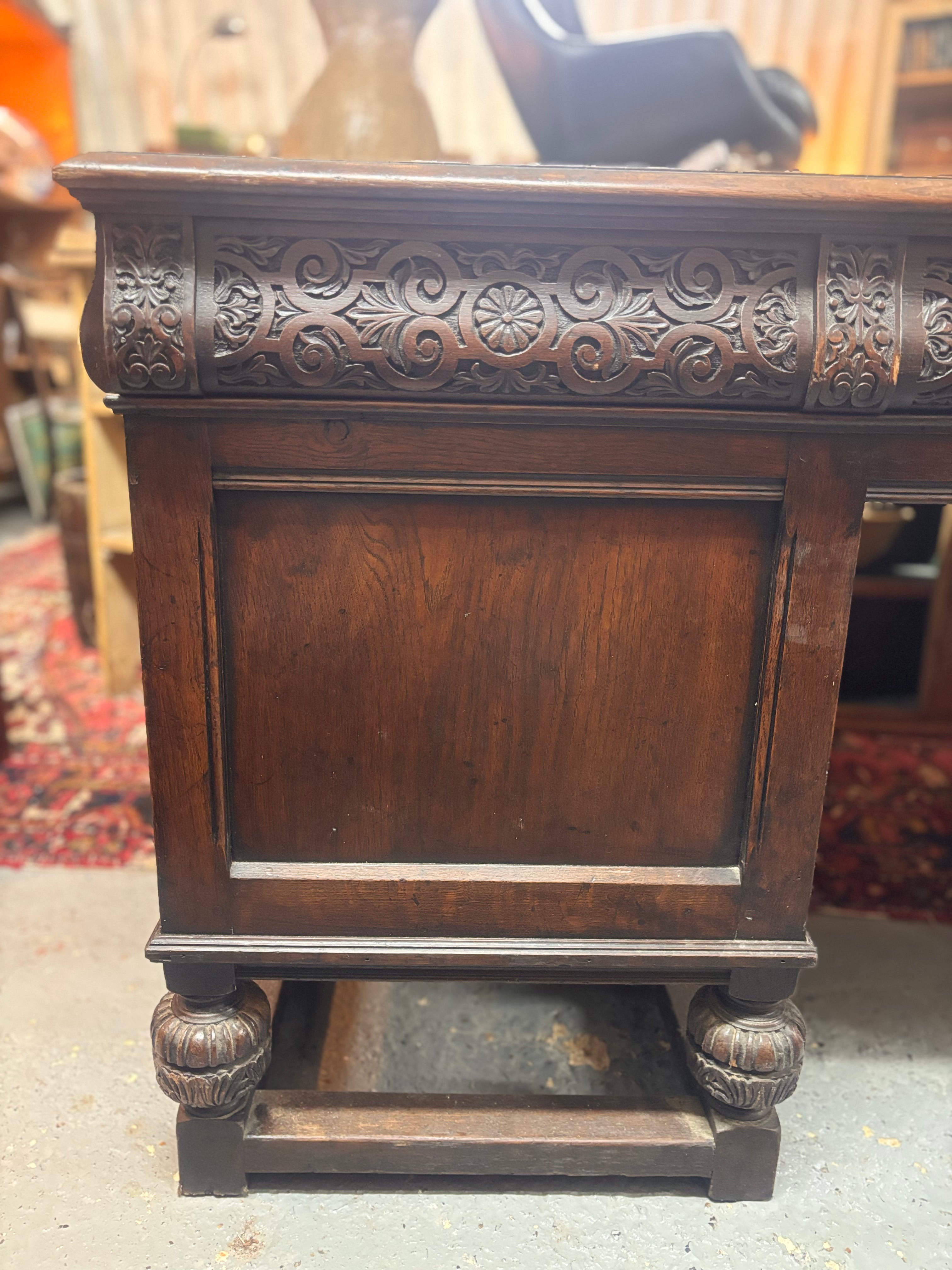Decorative wooden desk with intricate carvings on a blurred background