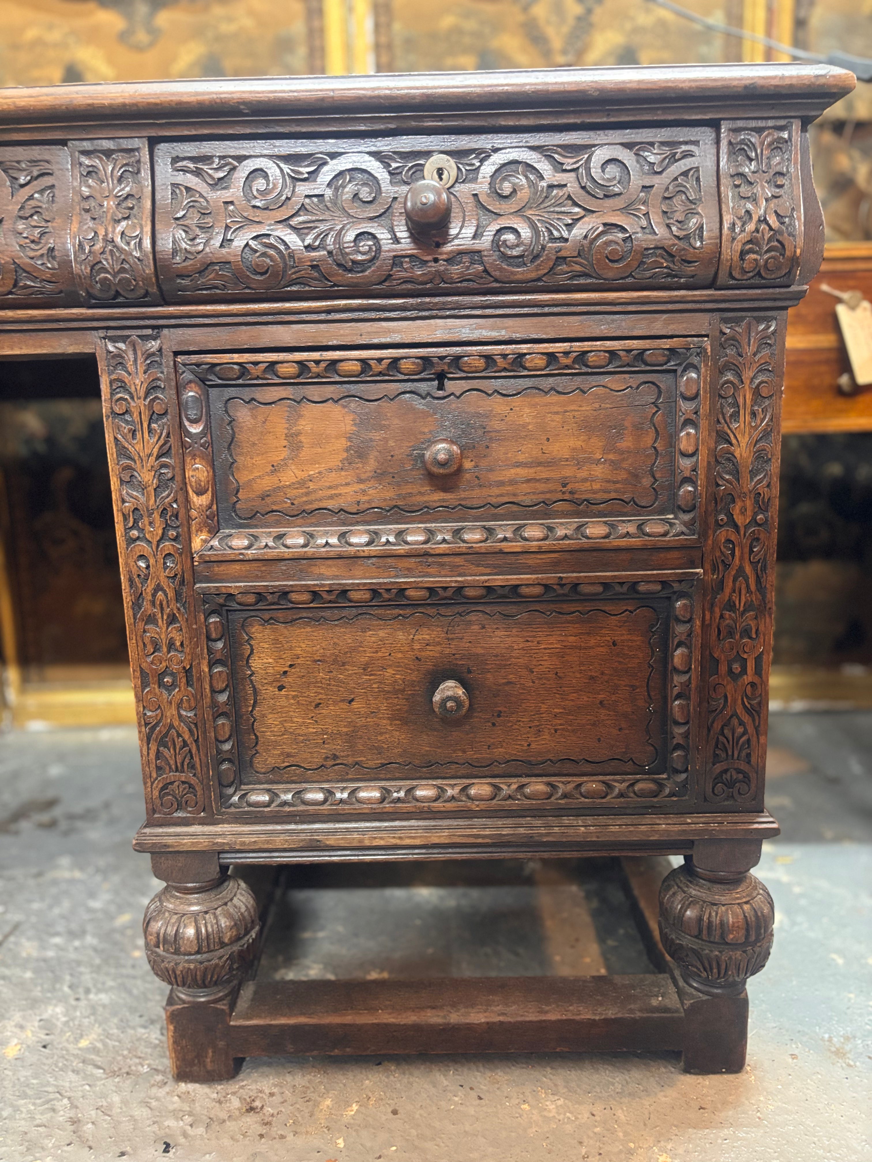 Carved wooden desk with two drawers and intricate patterns.