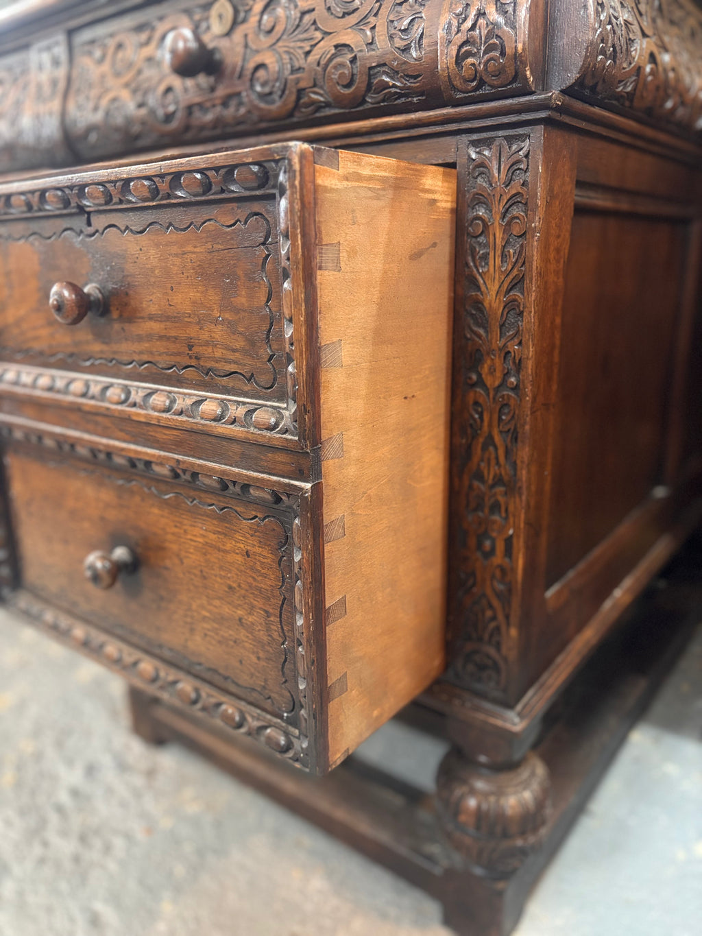 Close-up of an ornate wooden piece of furniture with carved details.